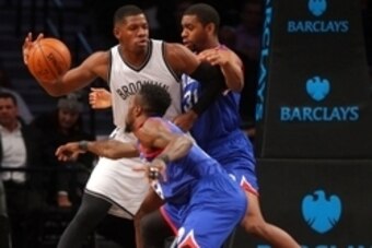Oct 20, 2014; Brooklyn, NY, USA; Brooklyn Nets shooting guard Joe Johnson (7) controls the ball while defended by Philadelphia 76ers shooting guard Hollis Thompson (31) and shooting guard Tony Wroten (8) during the first quarter at Barclays Center. Mandat