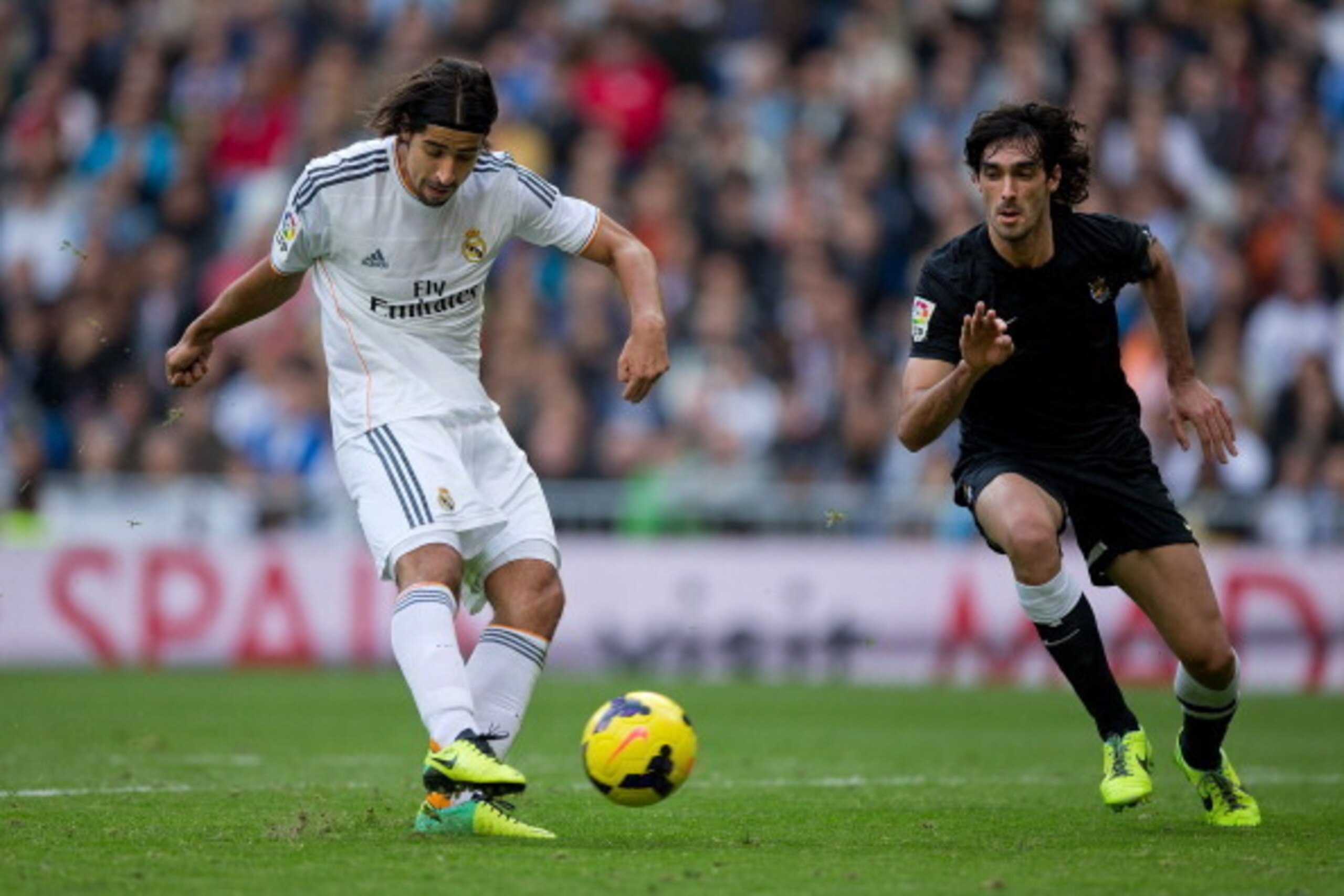 MADRID, SPAIN - NOVEMBER 09: Sami Khedira of Real Madrid CF scores their fourth goal against Carlos Martinez of Real Sociedad during the La Liga match between Real Madrid CF and Real Sociedad de Futbol  at Estadio Santiago Bernabeu on November 9, 2013 in 