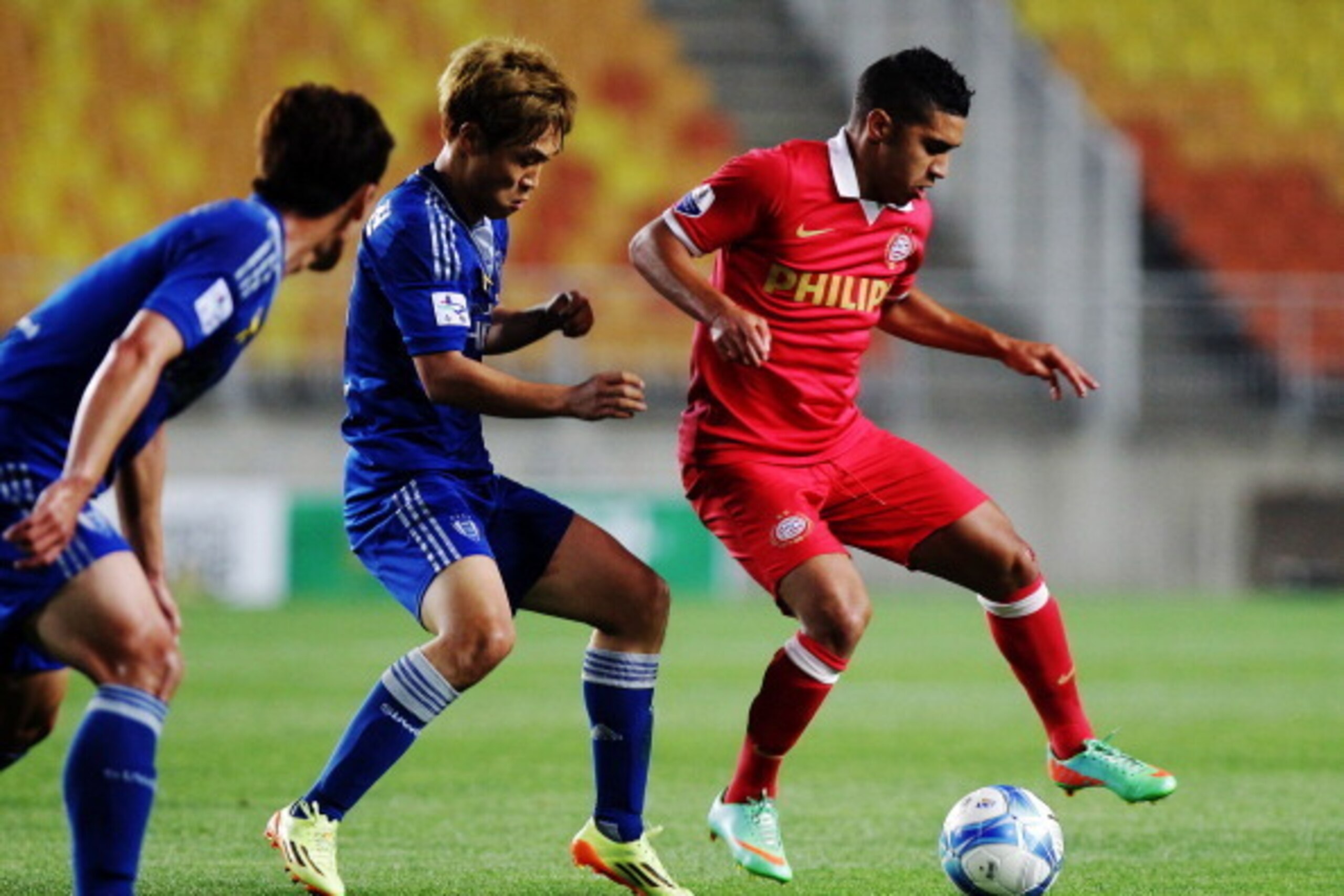 SUWON, SOUTH KOREA - MAY 22:  Zakaria Bakkali of PSV Eindhoven competes for the ball with Seo Jung-Jin of Suwon Samsung Bluewings during the friendly match between PSV Eindhoven and Suwon Samsung Bluewings at Suwon Worldcup Stadium on May 22, 2014 in Suwo