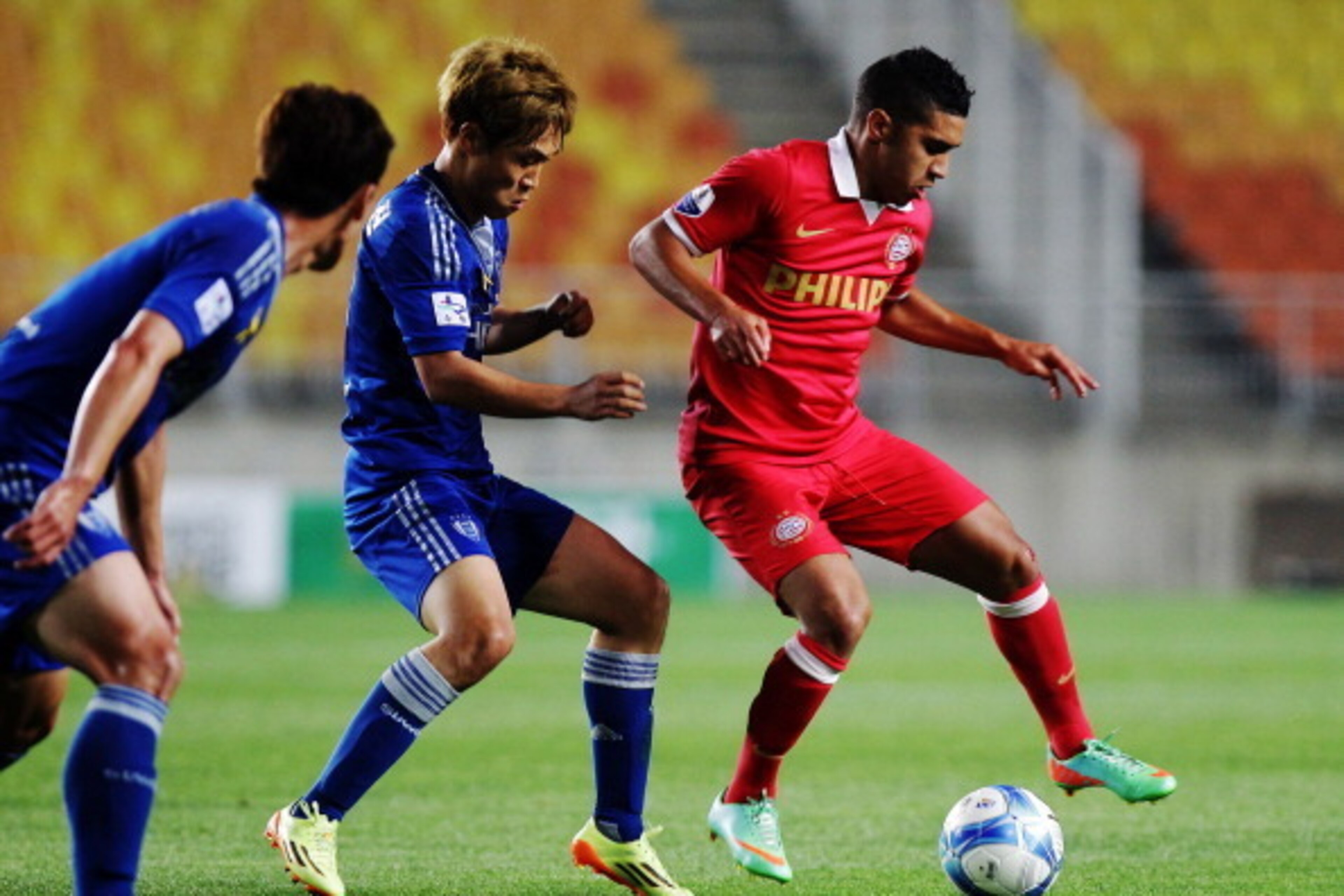 SUWON, SOUTH KOREA - MAY 22:  Zakaria Bakkali of PSV Eindhoven competes for the ball with Seo Jung-Jin of Suwon Samsung Bluewings during the friendly match between PSV Eindhoven and Suwon Samsung Bluewings at Suwon Worldcup Stadium on May 22, 2014 in Suwo