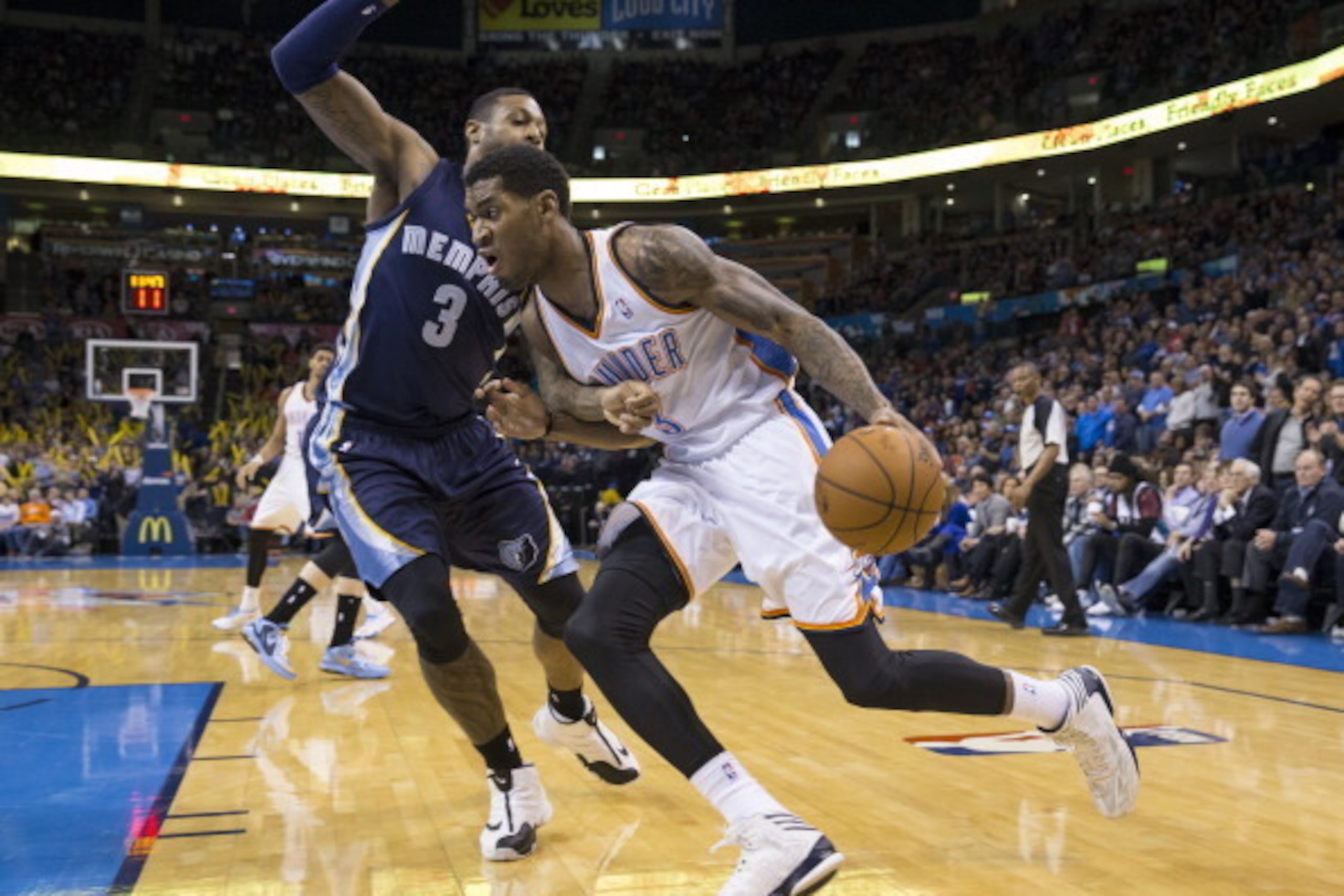 OKLAHOMA CITY, OK - FEBRUARY 3, 2014:  Perry Jones #3 of the Oklahoma City Thunder handles the ball against James Johnson #3 of the Memphis Grizzlies at the Chesapeake Arena on February 3, 2014 in Oklahoma City, Oklahoma. NOTE TO USER:  User expressly ack