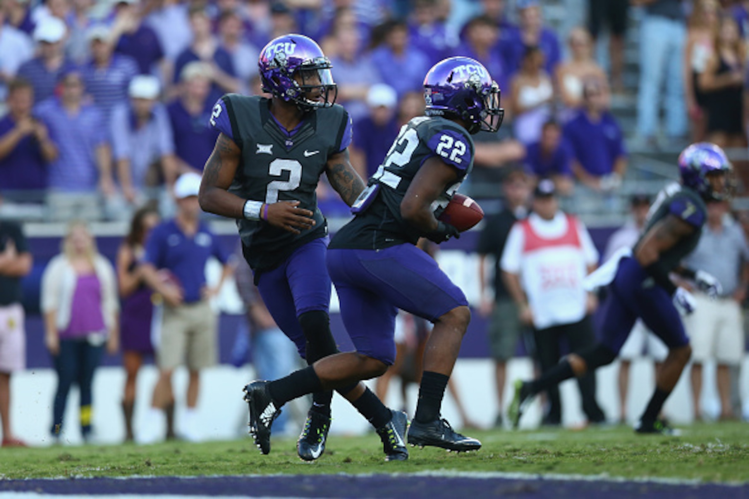 FORT WORTH, TX - OCTOBER 25:  Trevone Boykin #2 of the TCU Horned Frogs and Aaron Green #22 at Amon G. Carter Stadium on October 25, 2014 in Fort Worth, Texas.  (Photo by Ronald Martinez/Getty Images)