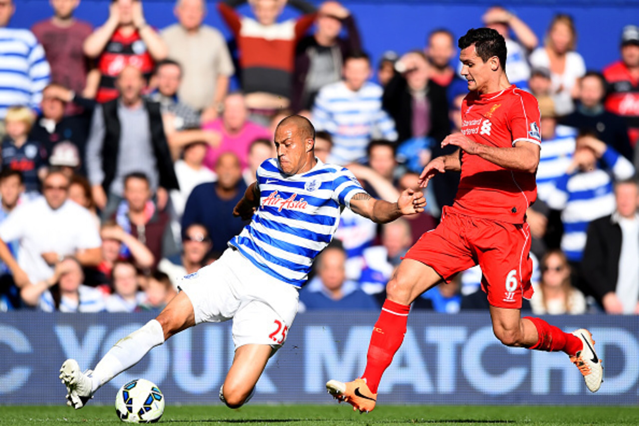 LONDON, ENGLAND - OCTOBER 19: Bobby Zamora of QPR slides for the ball next to Dejan Lovren of Liverpool during the Barclays Premier League match between Queens Park Rangers and Liverpool at Loftus Road on October 19, 2014 in London, England. (Photo by P LONDON, ENGLAND - OCTOBER 19: Bobby Zamora of QPR slides for the ball next to Dejan Lovren of Liverpool during the Barclays Premier League match between Queens Park Rangers and Liverpool at Loftus Road on October 19, 2014 in London, England. (Photo by P
