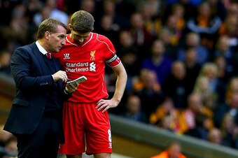 LIVERPOOL, ENGLAND - OCTOBER 25:  Brendan Rodgers, manager of Liverpool speaks with his captain Steven Gerrard as Steve Bruce manager of Hull City looks on during the Barclays Premier League match between Liverpool and Hull City at Anfield on October 25, 