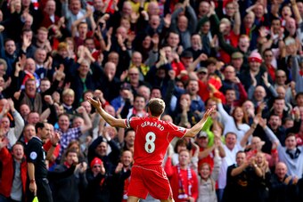 LIVERPOOL, ENGLAND - SEPTEMBER 27:  Steven Gerrard #8 of Liverpool infront of the home fans after scoring the opening goal from a free kick during the Barclays Premier League match between Liverpool and Everton at Anfield on September 27, 2014 in Liverpoo