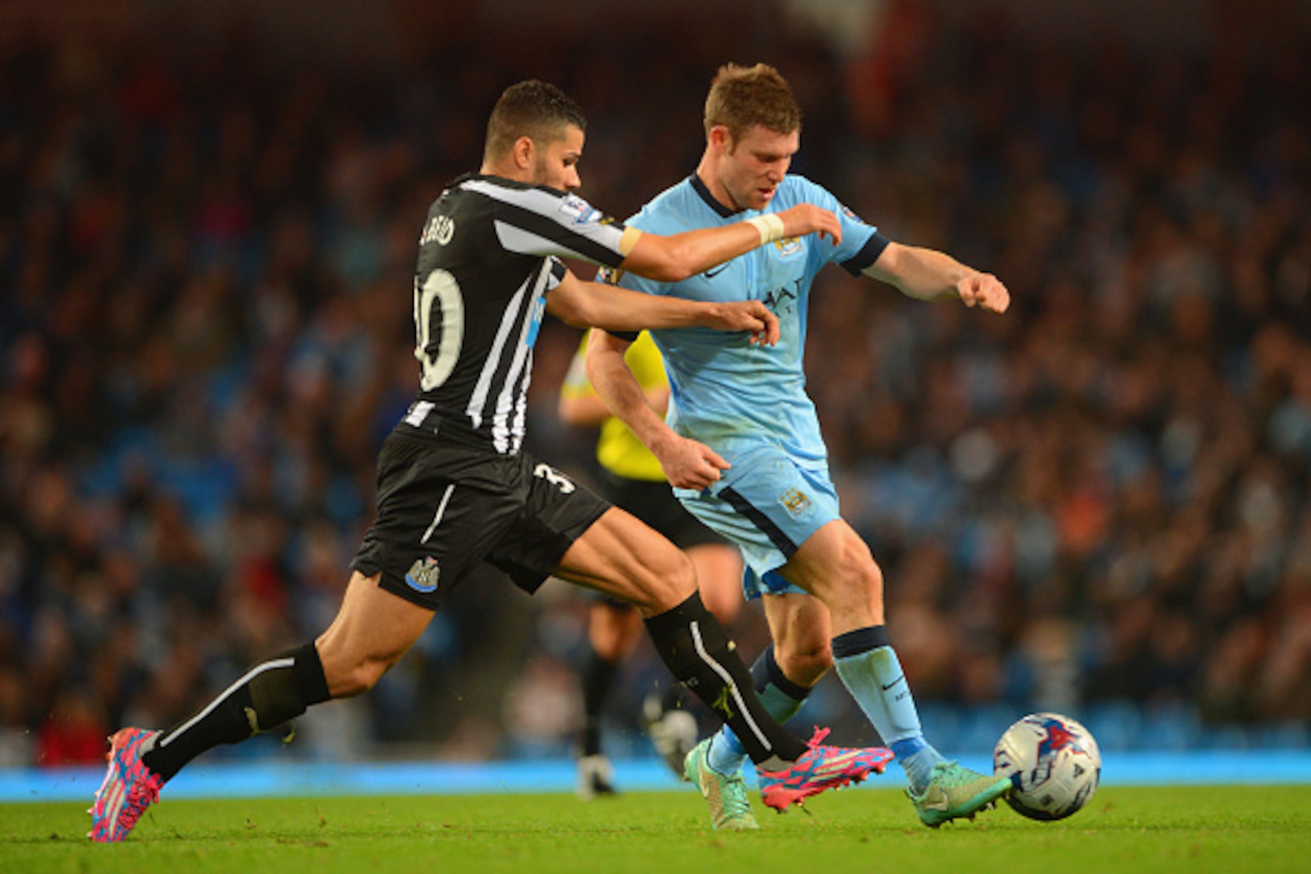 MANCHESTER, ENGLAND - OCTOBER 29: Mehdi Abeid of Newcastle United and James Milner of Manchester City battle for the ball during the Capital One Cup Fourth Round match between Manchester City and Newcastle United at Etihad Stadium on October 29, 2014 in M