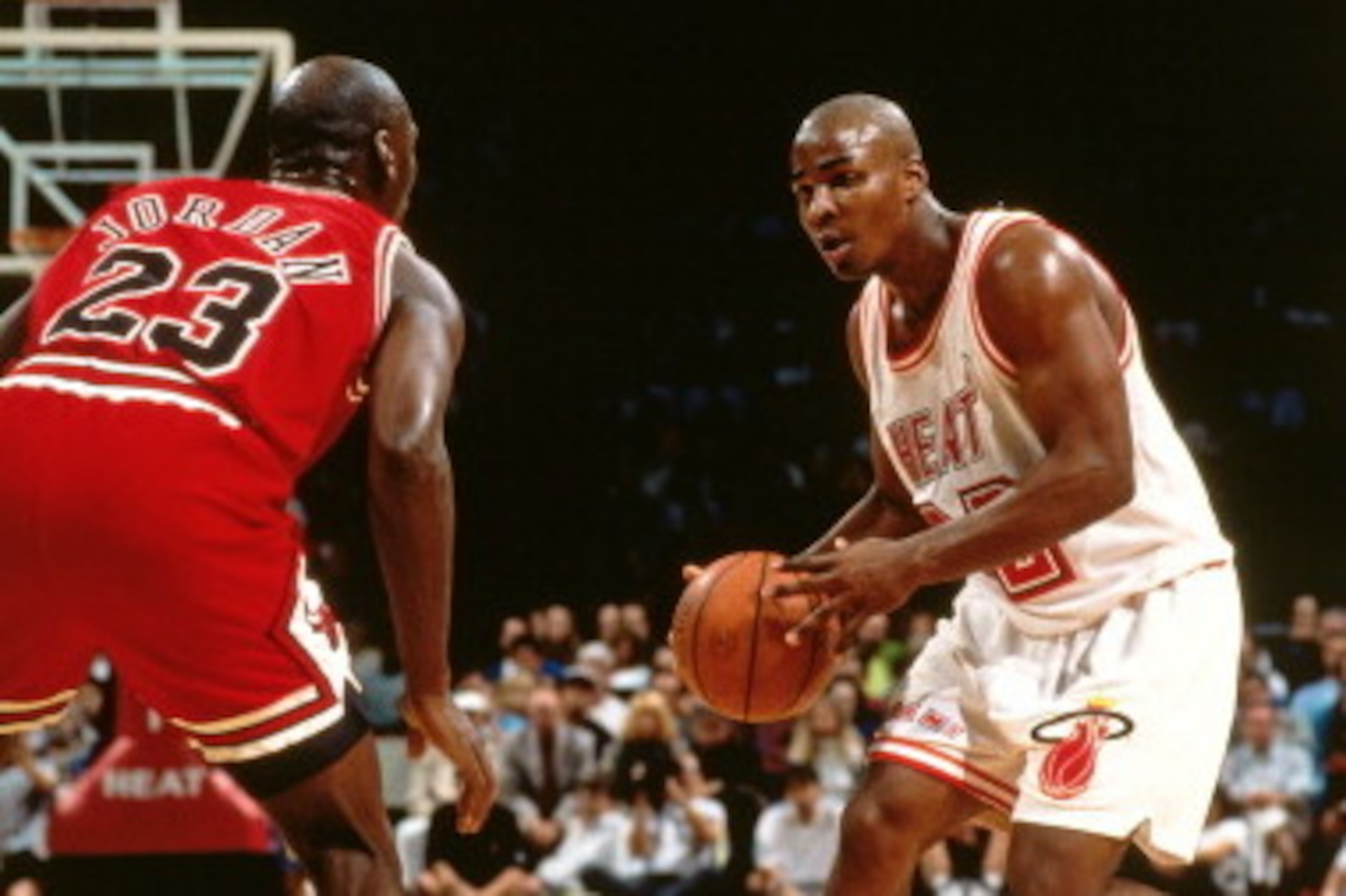 MIAMI - 1993: Harold Miner #32 of the Miami Heat dribbles against Michael Jordan #23 of the Chicago Bulls during a game played circa 1993 at Miami Arena in Miami Florida. NOTE TO USER: User expressly acknowledges and agrees that, by downloading and or usi