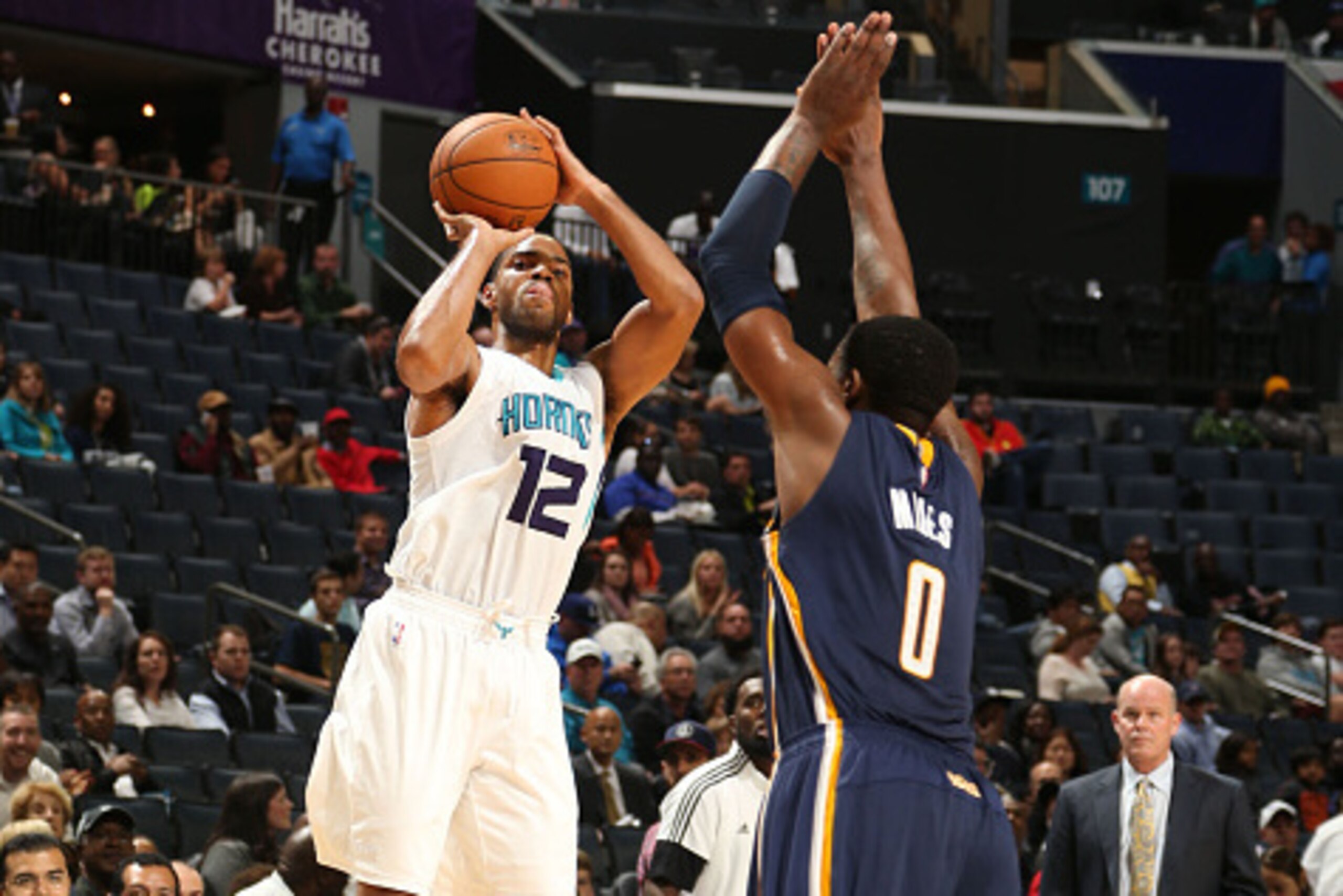CHARLOTTE, NC - OCTOBER 23: Gary Neal #12 of the Charlotte Hornets shoots against C.J. Miles #0 of the Indiana Pacers during the game at the Time Warner Cable Arena on October 23, 2014 in Charlotte, North Carolina. NOTE TO USER: User expressly acknowledge