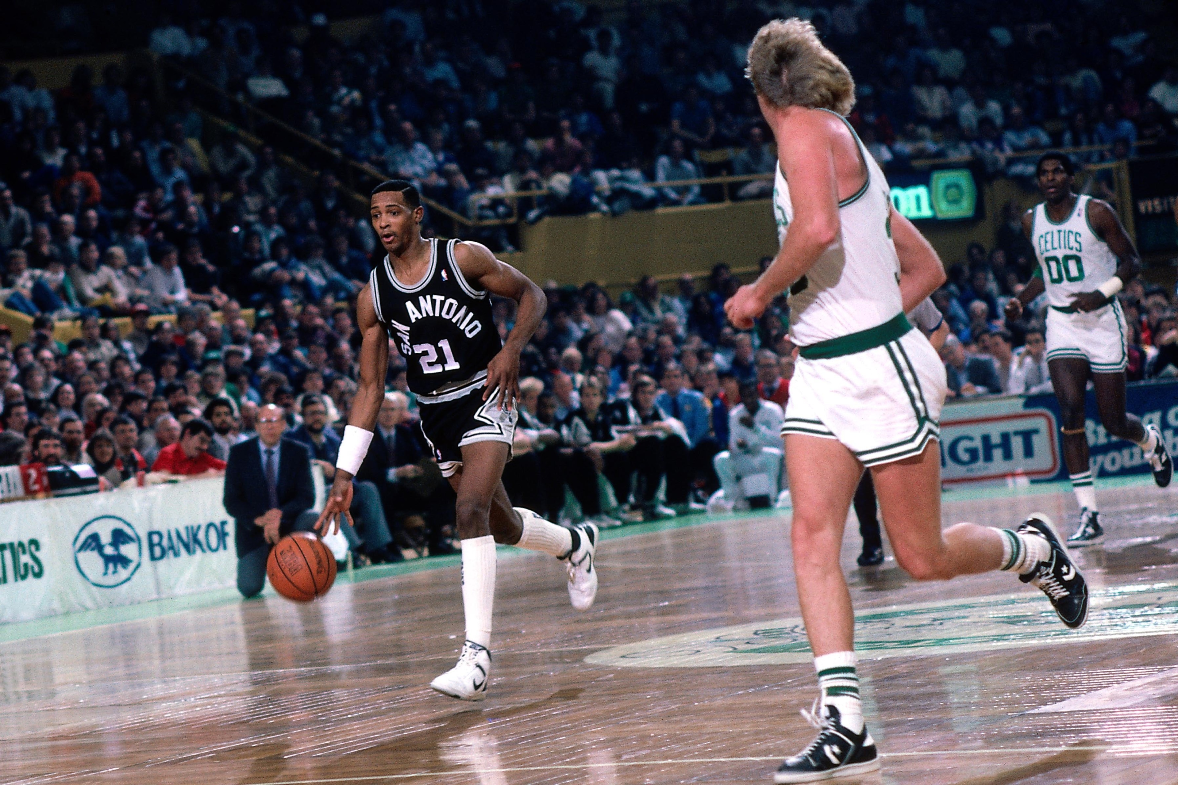 Alvin Robertson brings the ball upcourt against Larry Bird and the Celtics.