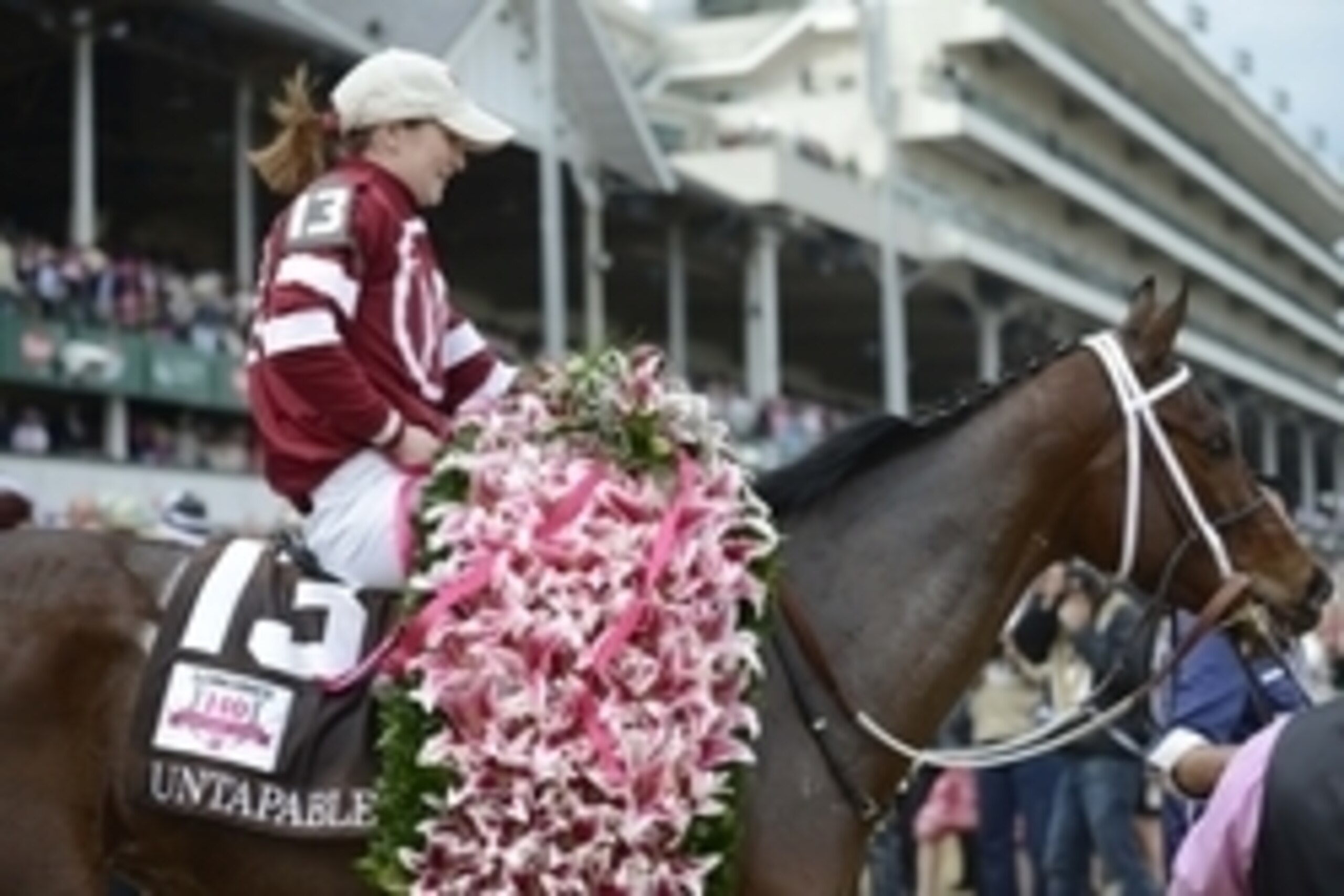 May 2, 2014; Louisville, KY, USA; Rosie Napravnik aboard Untapable (13) celebrates winning the 2014 Kentucky Oaks at Churchill Downs. Mandatory Credit: Jamie Rhodes-USA TODAY Sports