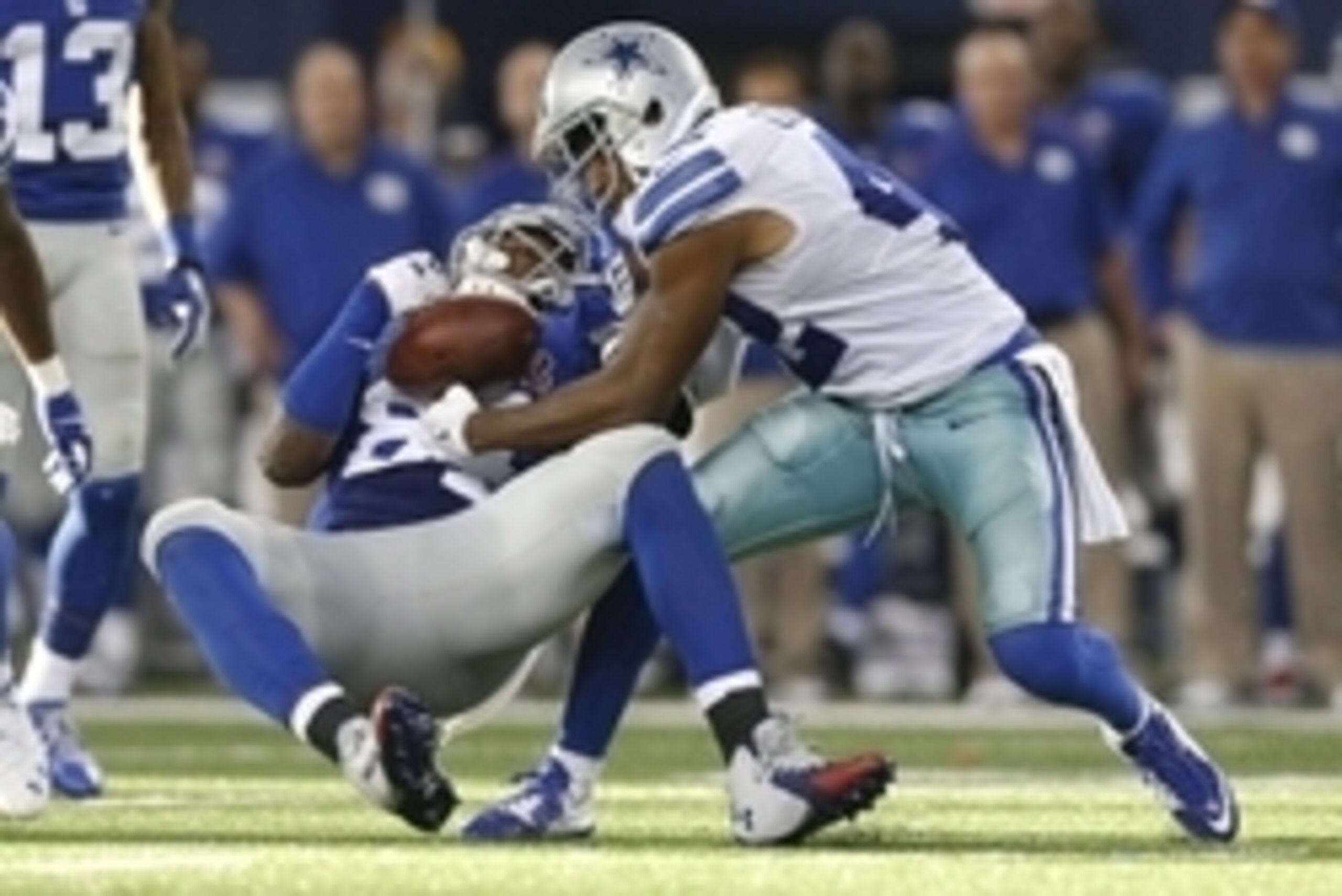 Oct 19, 2014; Arlington, TX, USA; Dallas Cowboys safety Barry Church (42) knocks the ball loose against New York Giants tight end Larry Donnell (84) in the fourth quarter at AT&T Stadium. Mandatory Credit: Matthew Emmons-USA TODAY Sports