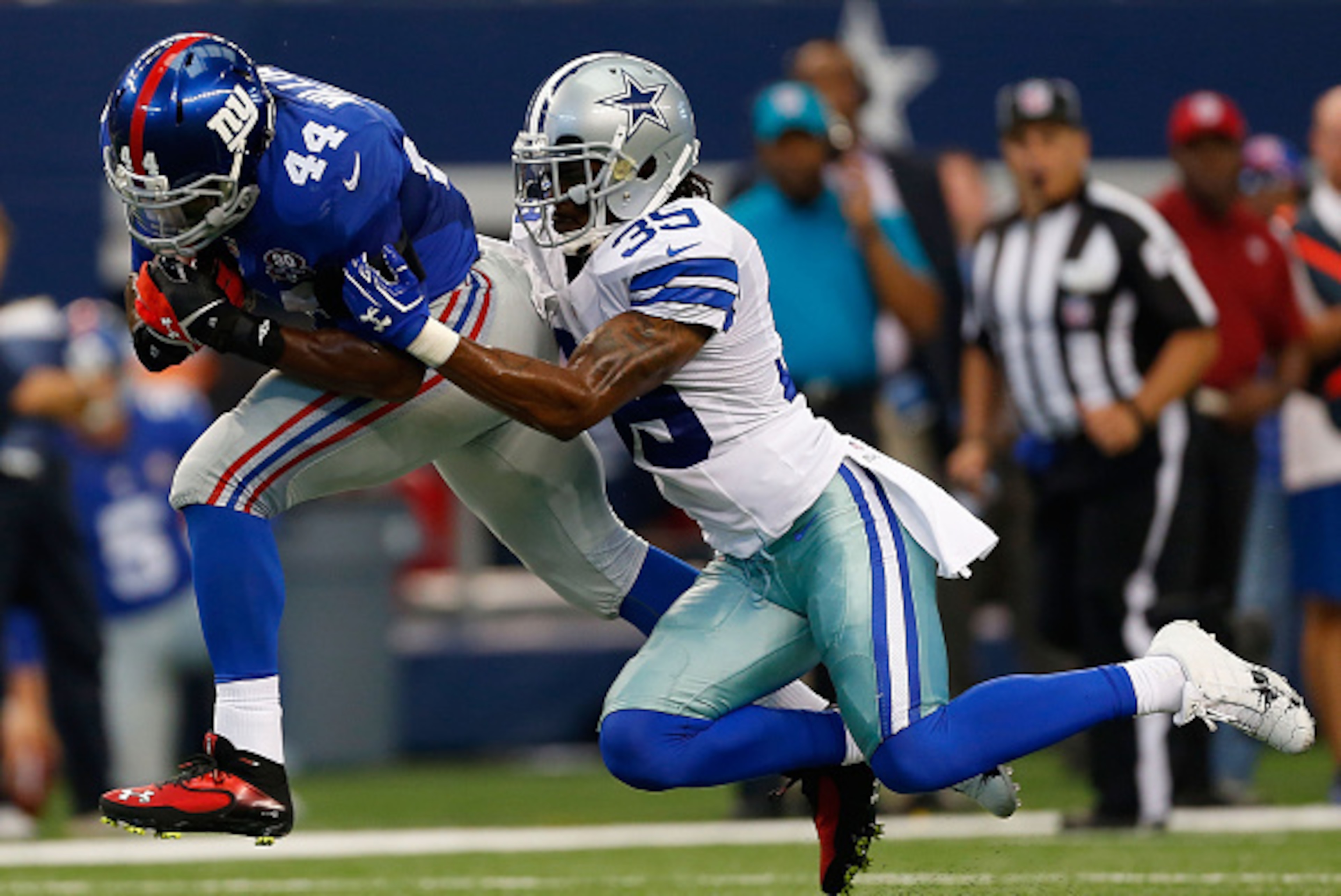 ARLINGTON, TX - OCTOBER 19:  Brandon Carr #39 of the Dallas Cowboys tries to bring down Andre Williams #44 of the New York Giants in the first half at AT&T Stadium on October 19, 2014 in Arlington, Texas.  (Photo by Wesley Hitt/Getty Images)