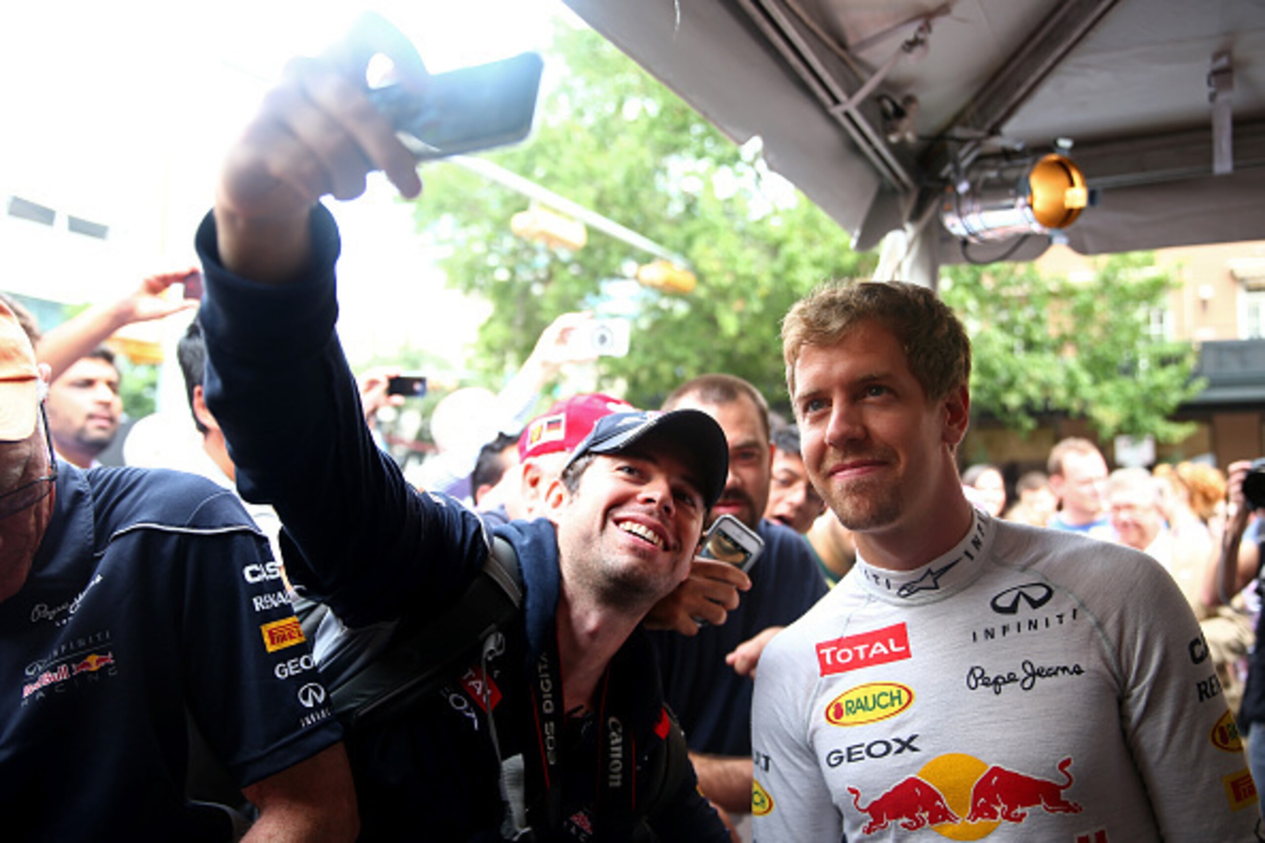 AUSTIN, TX - OCTOBER 29: Sebastian Vettel of Germany and Infiniti Red Bull Racing poses with fans during previews ahead of the United States Formula One Grand Prix on the streets of Austin on October 29, 2014 in Austin, United States. (Photo by Mark Tho AUSTIN, TX - OCTOBER 29: Sebastian Vettel of Germany and Infiniti Red Bull Racing poses with fans during previews ahead of the United States Formula One Grand Prix on the streets of Austin on October 29, 2014 in Austin, United States. (Photo by Mark Tho