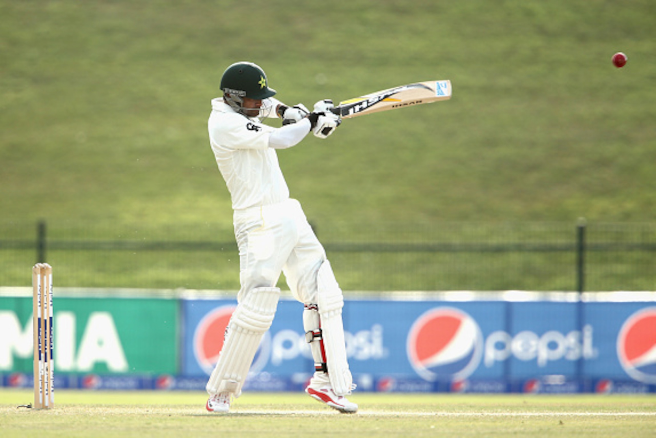 ABU DHABI, UNITED ARAB EMIRATES - NOVEMBER 01:  Mohammad Hafeez of Pakistan plays a shot and is caught by Mitchell Starc of Australia off the bowling of Mitchell Johnson during Day Three of the Second Test between Pakistan and Australia at Sheikh Zayed St