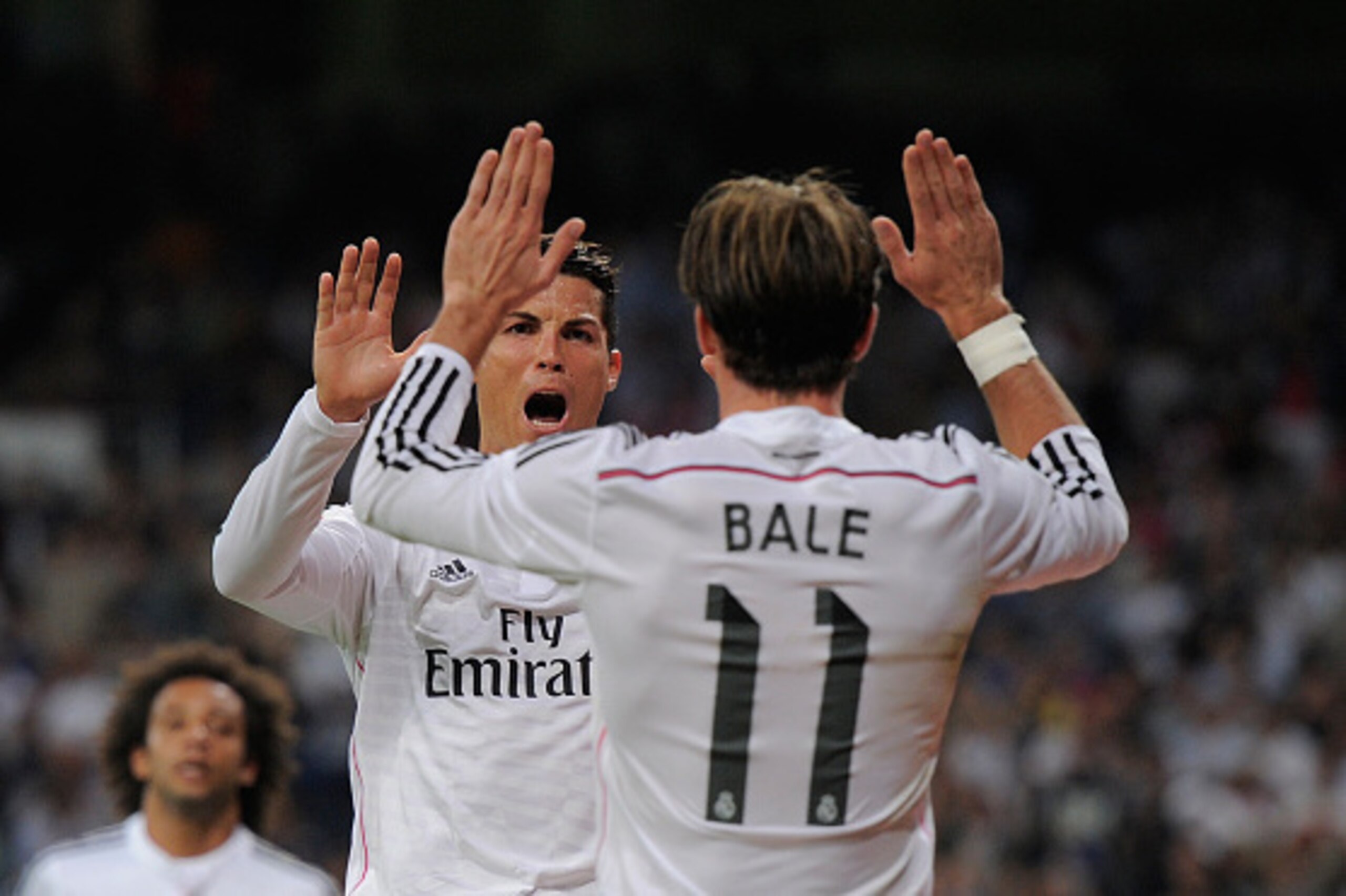 MADRID, SPAIN - OCTOBER 05:  Cristiano Ronaldo of Real Madrid celebrates with Gareth Bale after scoring his team's 3rd goal during the La Liga match between Real Madrid CF and Athletic Club at Estadio Santiago Bernabeu on October 5, 2014 in Madrid, Spain.