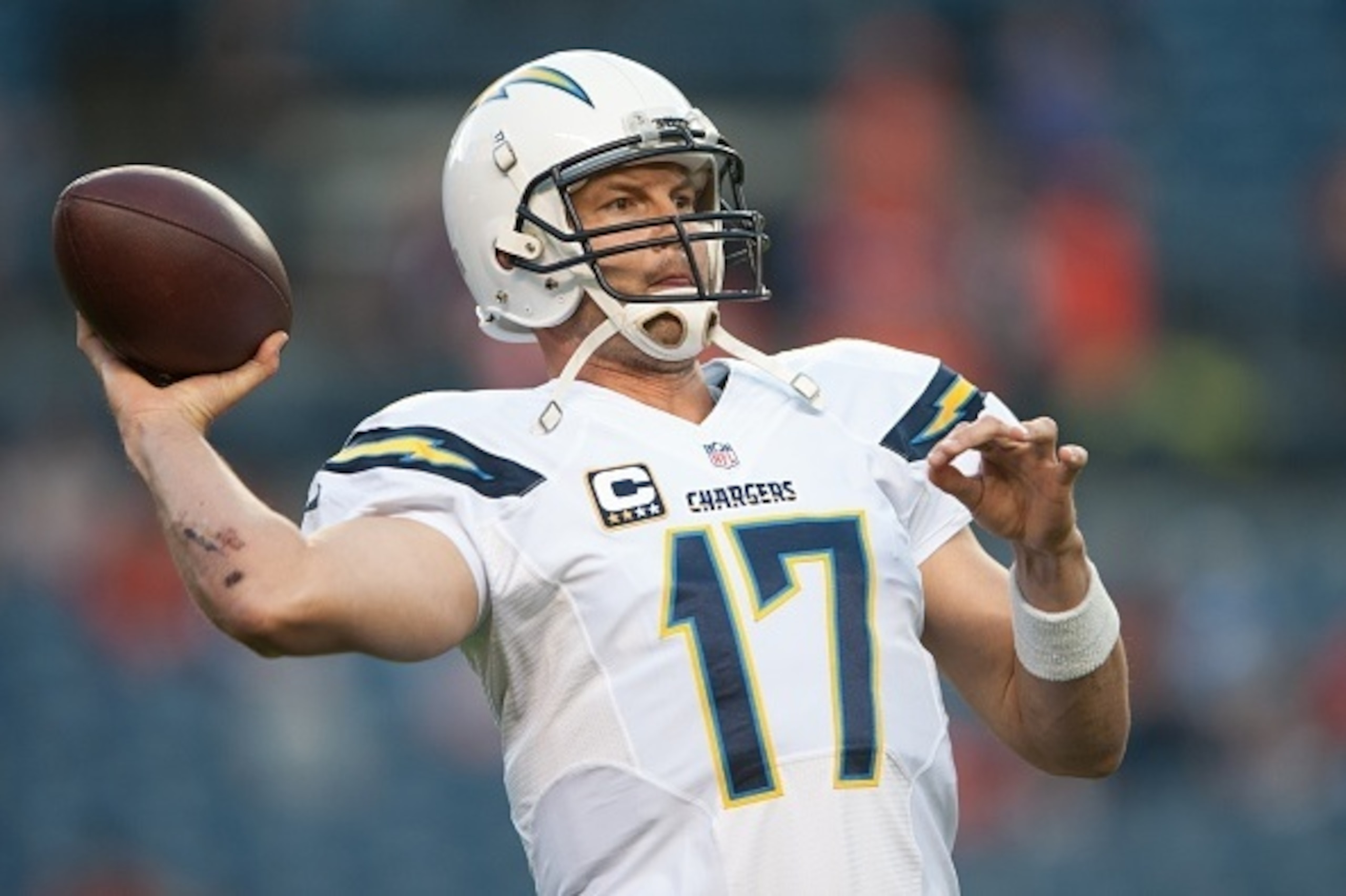 DENVER, CO - OCTOBER 23:  Quarterback Philip Rivers #17 of the San Diego Chargers throws as he warms up before a game against the Denver Broncos at Sports Authority Field at Mile High on October 23, 2014 in Denver, Colorado.  (Photo by Dustin Bradford/Get