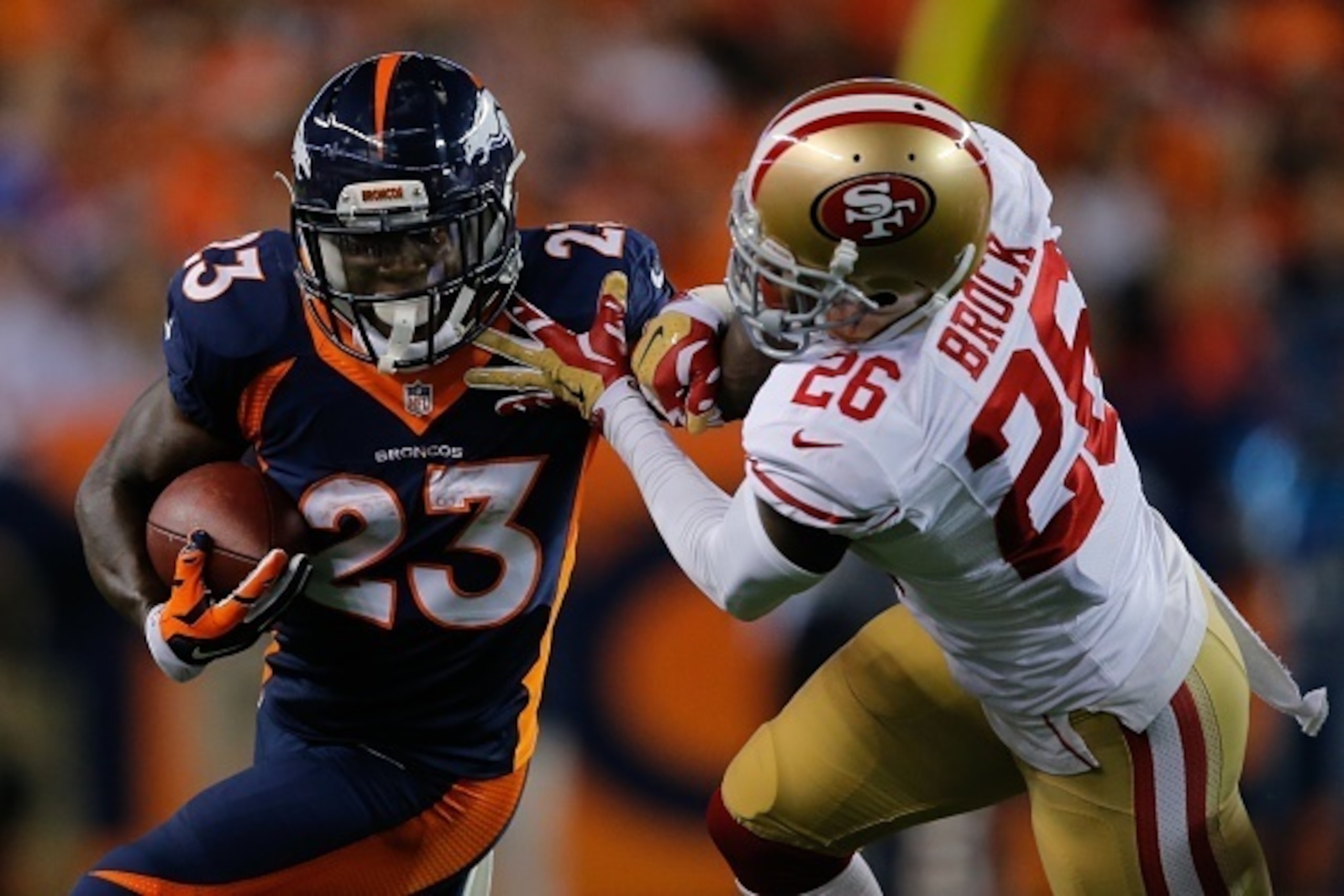 DENVER, CO - OCTOBER 19:  Running back Ronnie Hillman #23 of the Denver Broncos rushes against cornerback Tramaine Brock #26 of the San Francisco 49ers during a game at Sports Authority Field at Mile High on October 19, 2014 in Denver, Colorado.  (Photo b