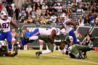 EAST RUTHERFORD, NJ - OCTOBER 26:   Jarius Wynn #92 of the Buffalo Bills sacks quarterback Michael Vick #1 of the New York Jets in the fourth quarter at MetLife Stadium on October 26, 2014 in East Rutherford, New Jersey.  (Photo by Alex Goodlett/Getty Ima