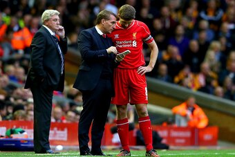 LIVERPOOL, ENGLAND - OCTOBER 25:  Brendan Rodgers, manager of Liverpool speaks with his captain Steven Gerrard as Steve Bruce manager of Hull City looks on during the Barclays Premier League match between Liverpool and Hull City at Anfield on October 25, 