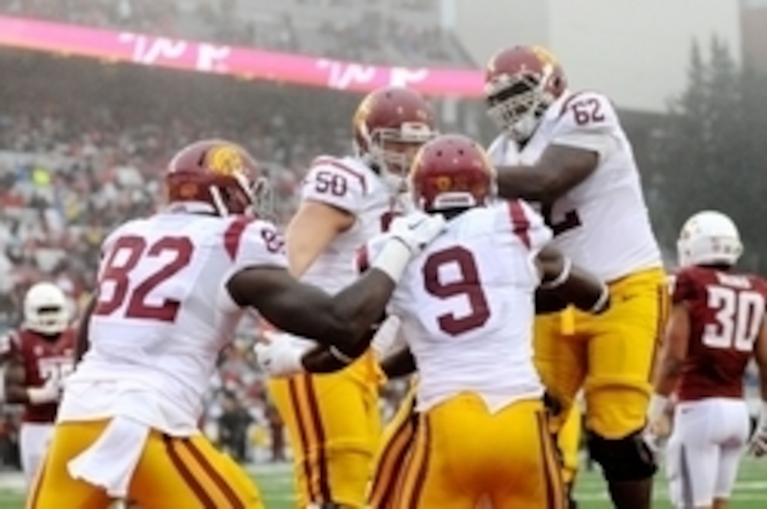 Nov 1, 2014; Pullman, WA, USA; Southern California Trojans offense celebrates a touchdown against the Washington State Cougars during the first half at Martin Stadium. Mandatory Credit: James Snook-USA TODAY Sports