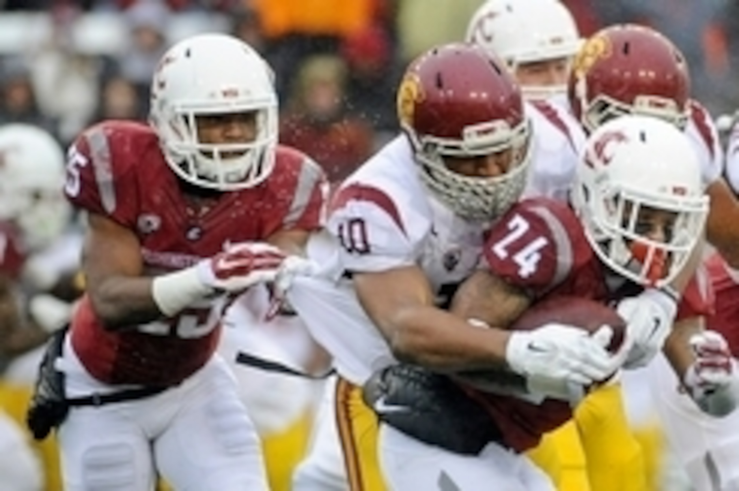 Nov 1, 2014; Pullman, WA, USA; Washington State Cougars running back Theron West (24) is tackled by Southern California Trojans linebacker Hayes Pullard (10) during the first half at Martin Stadium. Mandatory Credit: James Snook-USA TODAY Sports