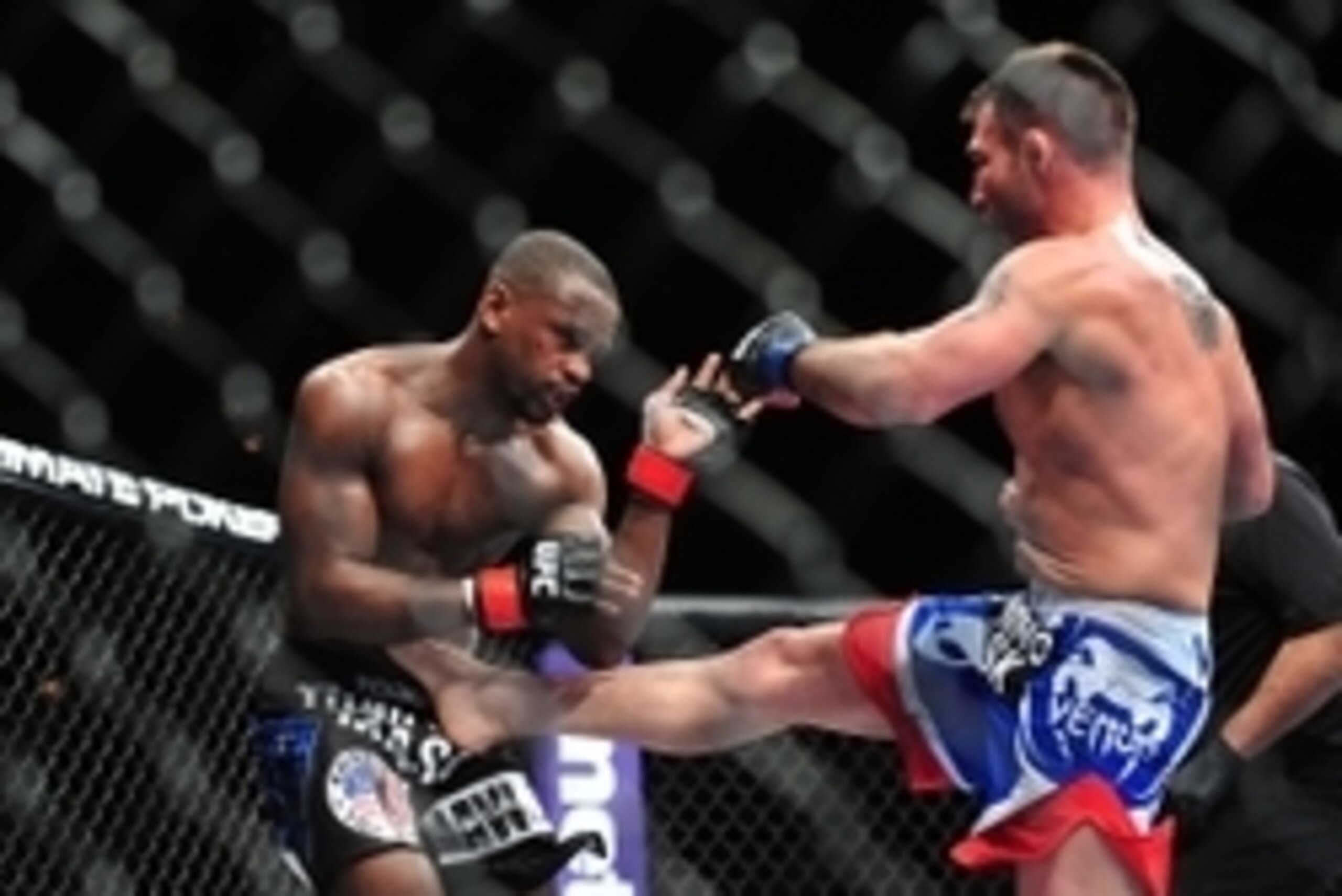 Feb 2, 2013; Las Vegas, NV, USA; Issac Vallie-Flagg (right) lands a kick to Yves Edwards (left) during UFC 156 at the Mandalay Bay Events Center. Mandatory Credit: Gary A. Vasquez-USA TODAY Sports