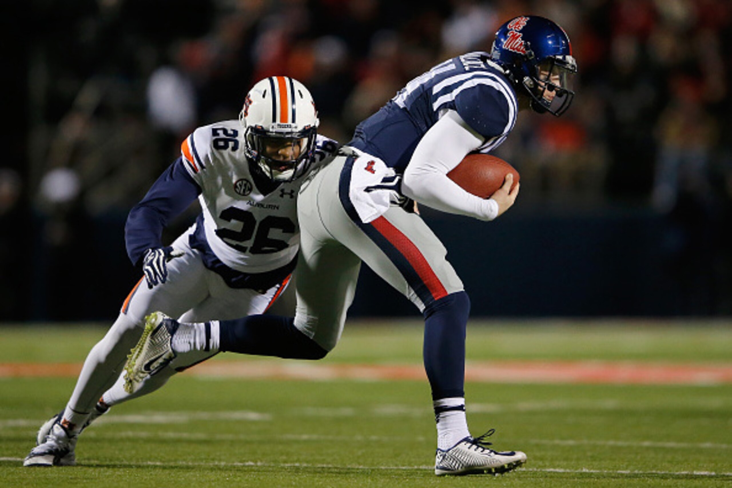 OXFORD, MS - NOVEMBER 01:  Quarterback Bo Wallace #14 of the Mississippi Rebels is tackled by Justin Garrett #26 of the Auburn Tigers short of a first down forcing the Rebels to punt in the second quarter at Vaught-Hemingway Stadium on November 1, 2014 in