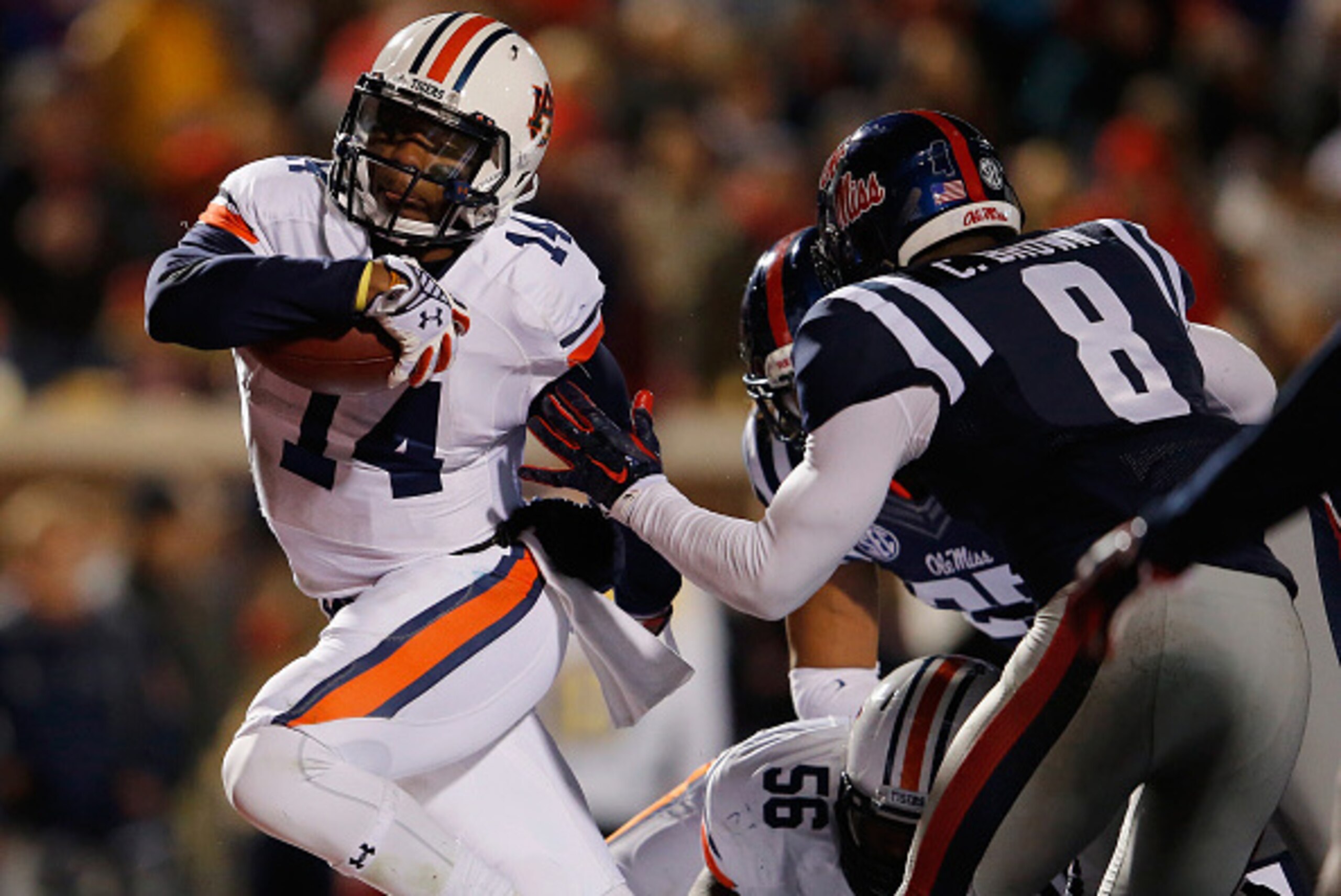 OXFORD, MS - NOVEMBER 01:  Quarterback Nick Marshall #14 of the Auburn Tigers rushes 2 yards for a touchdown against Chief Brown #8 of the Mississippi Rebels as the Rebels held a 24-21 lead in the third quarter at Vaught-Hemingway Stadium on November 1, 2