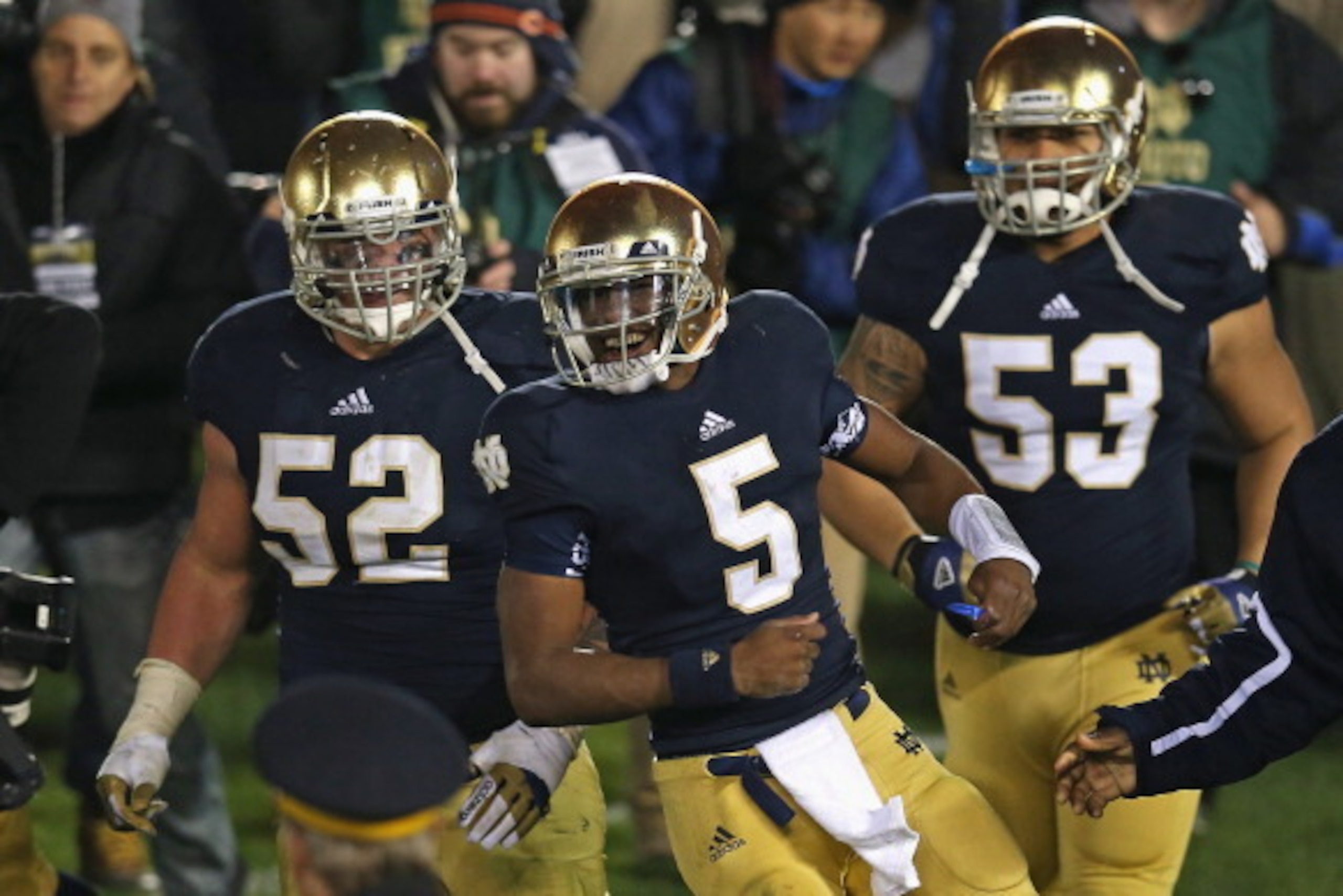 SOUTH BEND, IN - NOVEMBER 03: Everett Golson  #5, Braxston Cave #52 and Justin Utupo #53 of the Notre Dame Fighting Irish celebrate after Golson ran for the game-winning touchdown against the Pittsburgh Panthers at Notre Dame Stadium on November 3, 2012 i