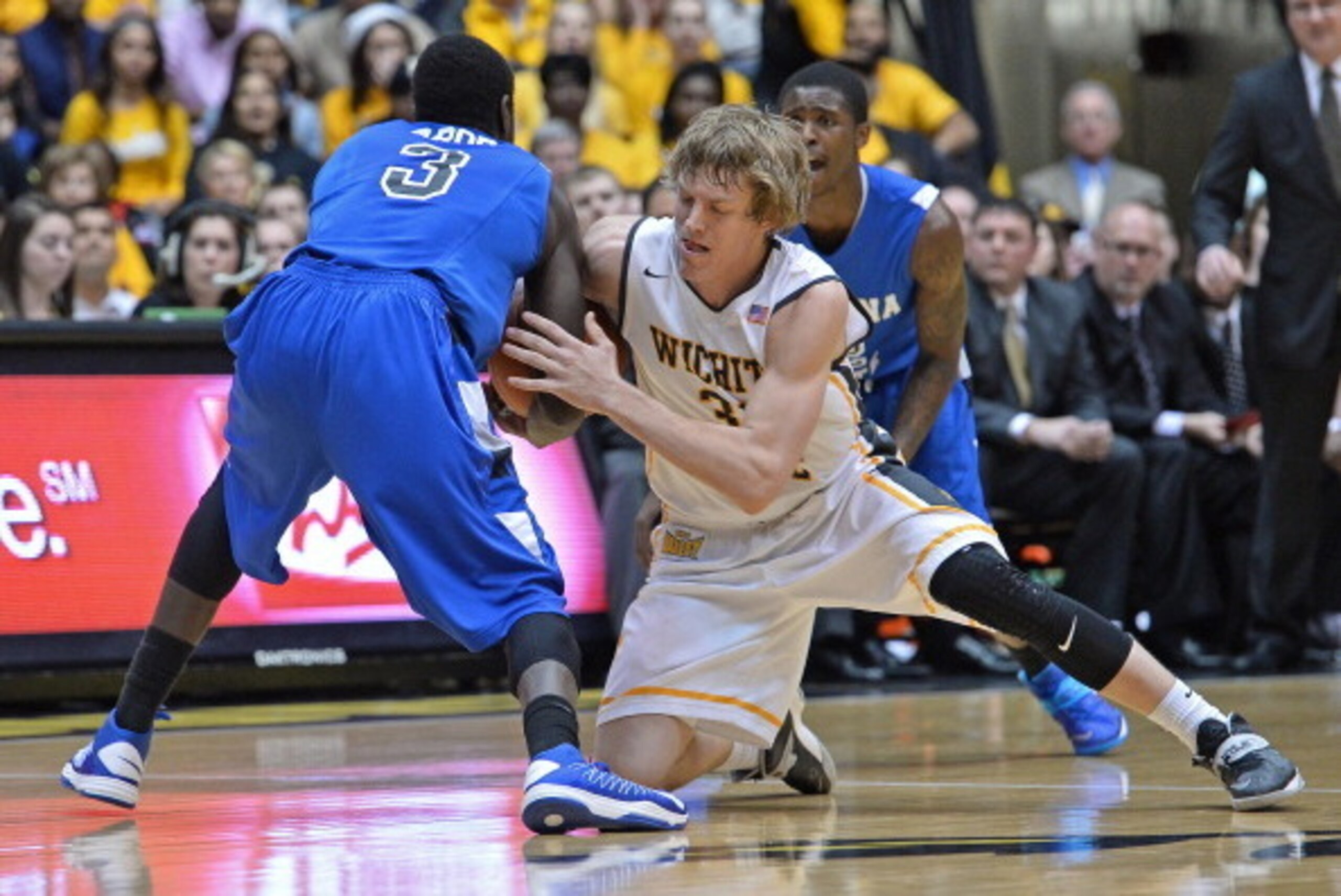 WICHITA, KS - JANUARY 18:  Guard Ron Baker #31 of the Wichita State Shockers reaches in for a loose ball against guard Manny Arop #3 of the Indiana State Sycamores during the first half on January 18, 2014 at Charles Koch Arena in Wichita, Kansas.  (Photo