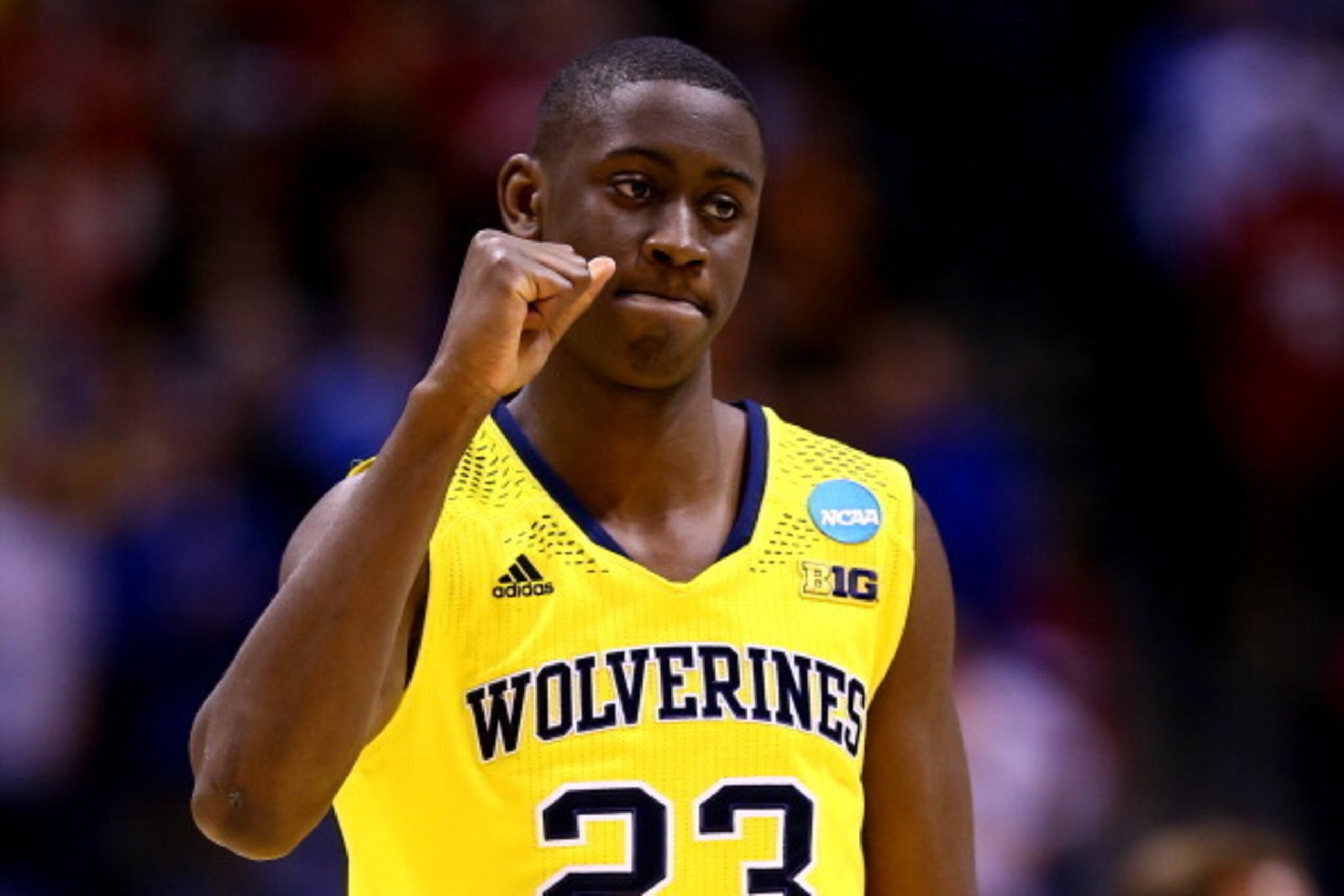 INDIANAPOLIS, IN - MARCH 28:  Caris LeVert #23 of the Michigan Wolverines celebrates defeating the Tennessee Volunteers 73 to 71 during the regional semifinal of the 2014 NCAA Men's Basketball Tournament at Lucas Oil Stadium on March 28, 2014 in Indianapo