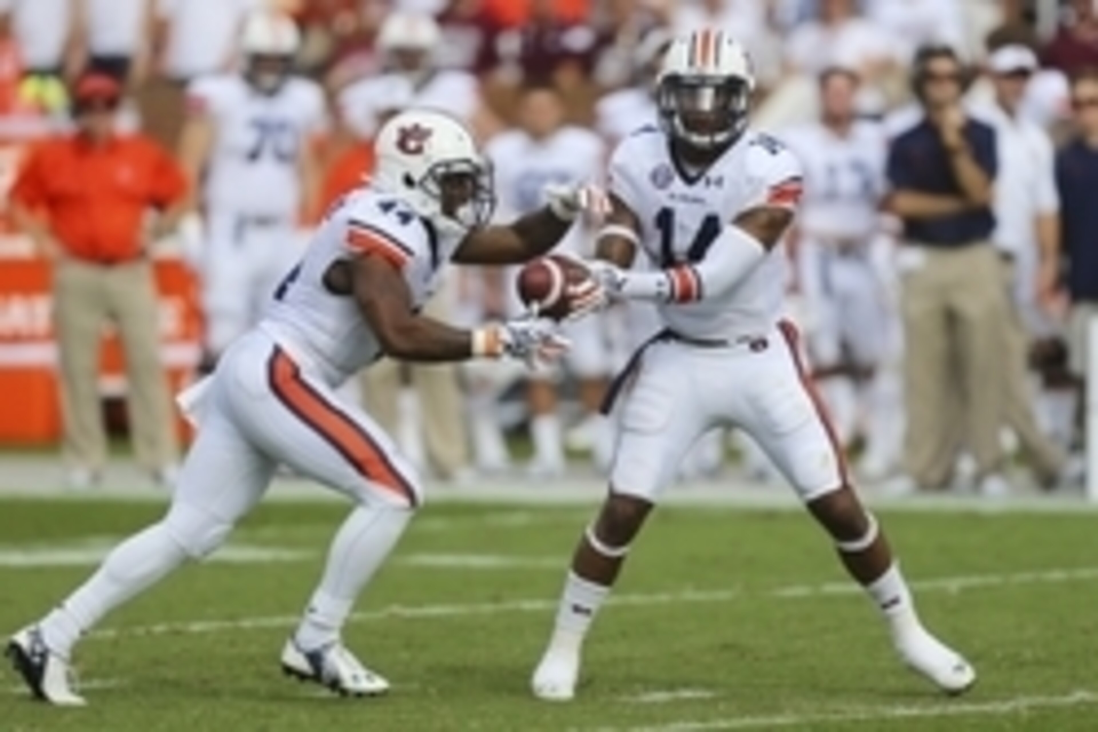 Oct 11, 2014; Starkville, MS, USA; Auburn Tigers quarterback Nick Marshall (14) hands the ball off to running back Cameron Artis-Payne (44) during the game at Davis Wade Stadium. Mandatory Credit: Spruce Derden-USA TODAY Sports Oct 11, 2014; Starkville, MS, USA; Auburn Tigers quarterback Nick Marshall (14) hands the ball off to running back Cameron Artis-Payne (44) during the game at Davis Wade Stadium. Mandatory Credit: Spruce Derden-USA TODAY Sports