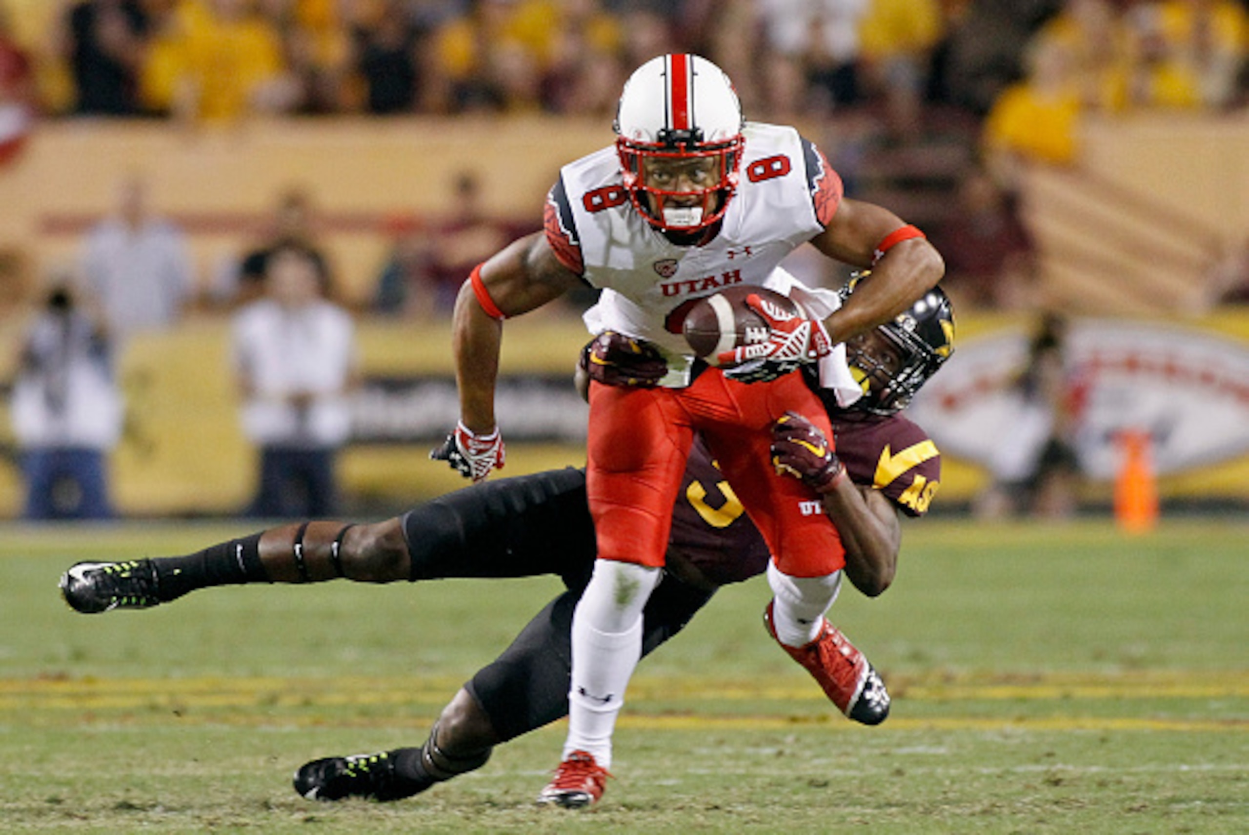 TEMPE, AZ - NOVEMBER 01:  Receiver Kaelin Clay #8 of the Utah Utes is tackled by Damarious Randall #3 of the Arizona State Sun Devils after a reception during the second quarter of a college football game at Sun Devil Stadium on November 1, 2014 in Tempe,