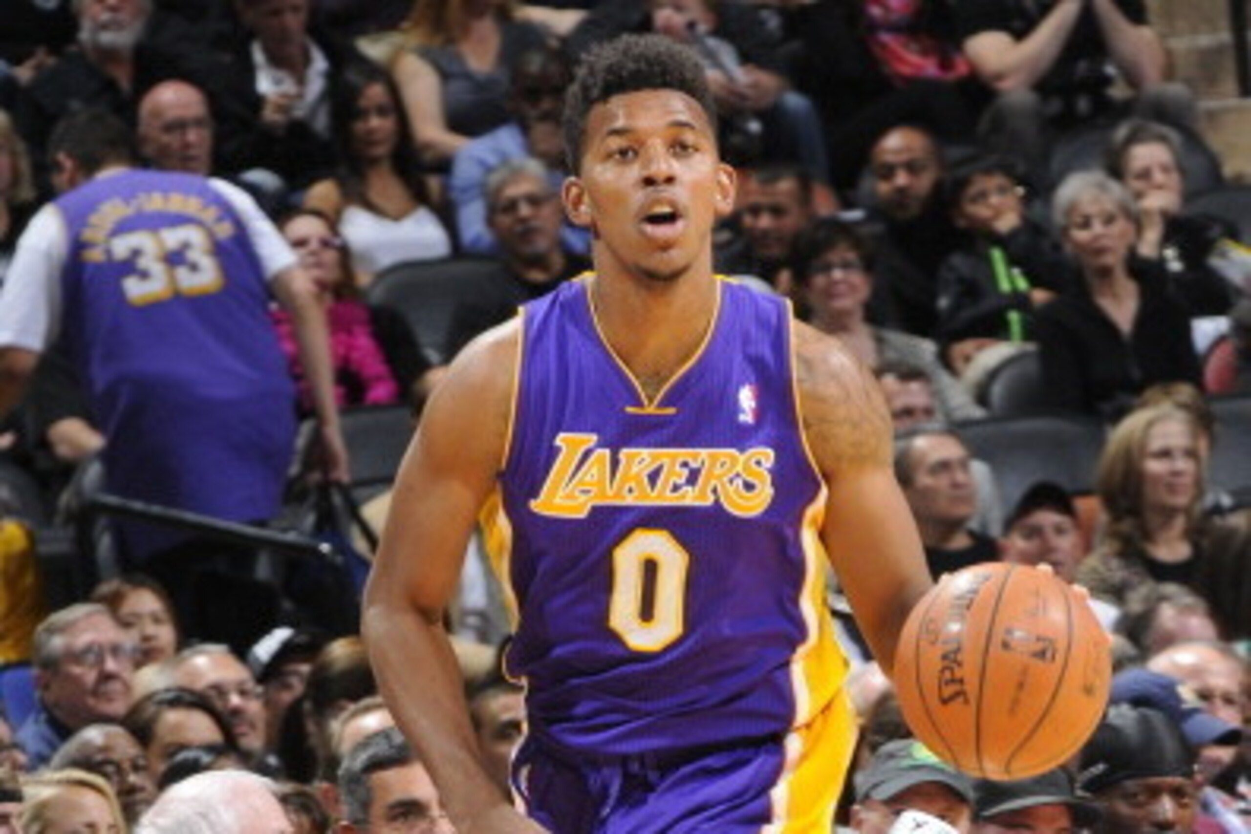 SAN ANTONIO, TX - April 16: Nick Young #0 of the Los Angeles Lakers handles the ball against the San Antonio Spurs during the game at the AT&T Center on April 16, 2014 in San Antonio, Texas. NOTE TO USER: User expressly acknowledges and agrees that, by do