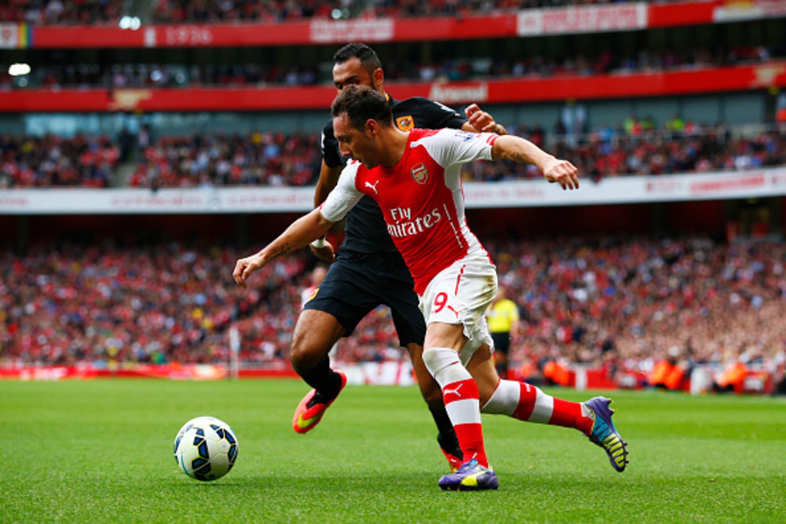 LONDON, ENGLAND - OCTOBER 18:  Santi Cazorla of Arsenal battles for the ball with Ahmed Elmohamady of Hull City during the Barclays Premier League match between Arsenal and Hull City at Emirates Stadium on October 18, 2014 in London, England.  (Photo by C
