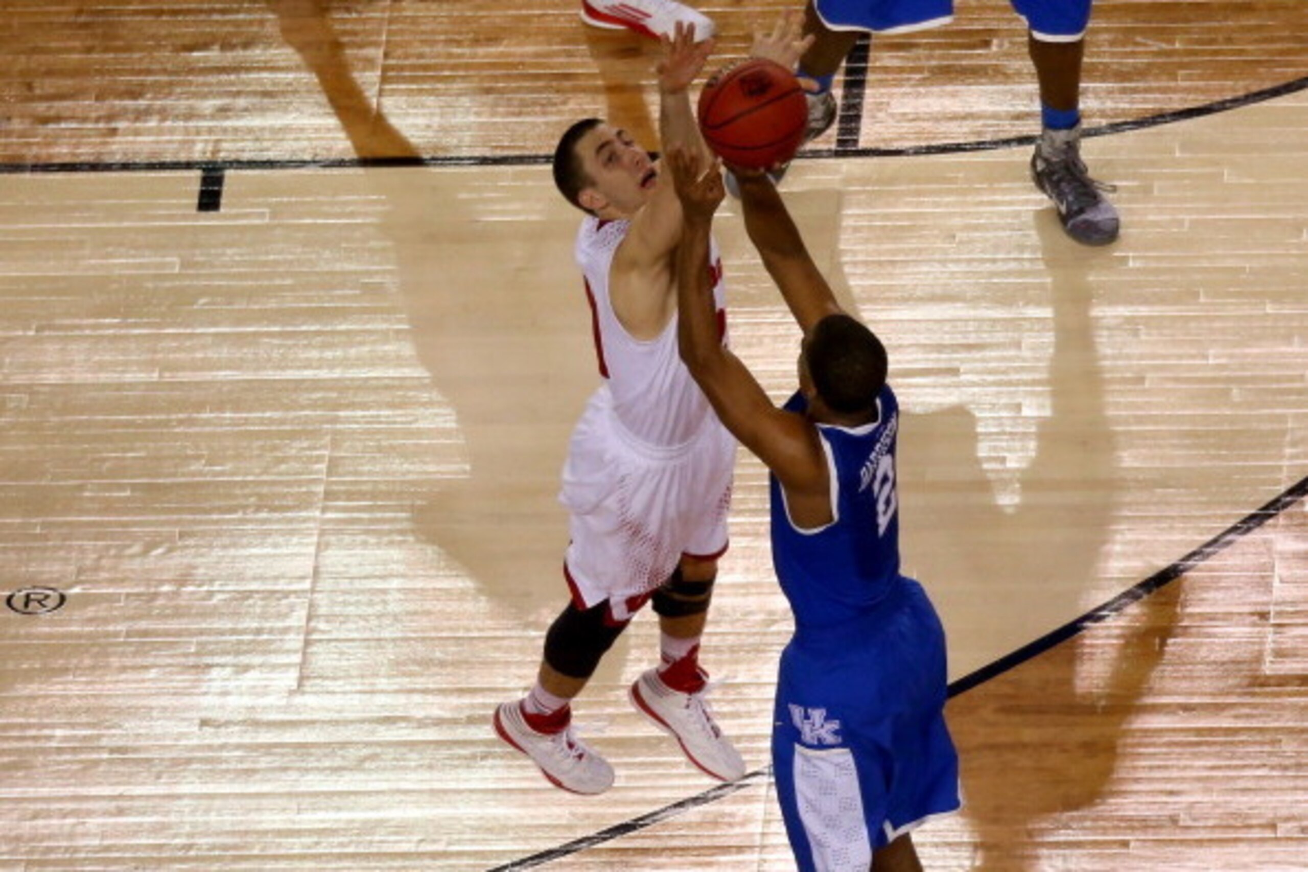 ARLINGTON, TX - APRIL 05: Aaron Harrison #2 of the Kentucky Wildcats hits the game winning shot as Josh Gasser #21 of the Wisconsin Badgers defends during the NCAA Men's Final Four Semifinal at AT&T Stadium on April 5, 2014 in Arlington, Texas. The Kentu ARLINGTON, TX - APRIL 05: Aaron Harrison #2 of the Kentucky Wildcats hits the game winning shot as Josh Gasser #21 of the Wisconsin Badgers defends during the NCAA Men's Final Four Semifinal at AT&T Stadium on April 5, 2014 in Arlington, Texas. The Kentu