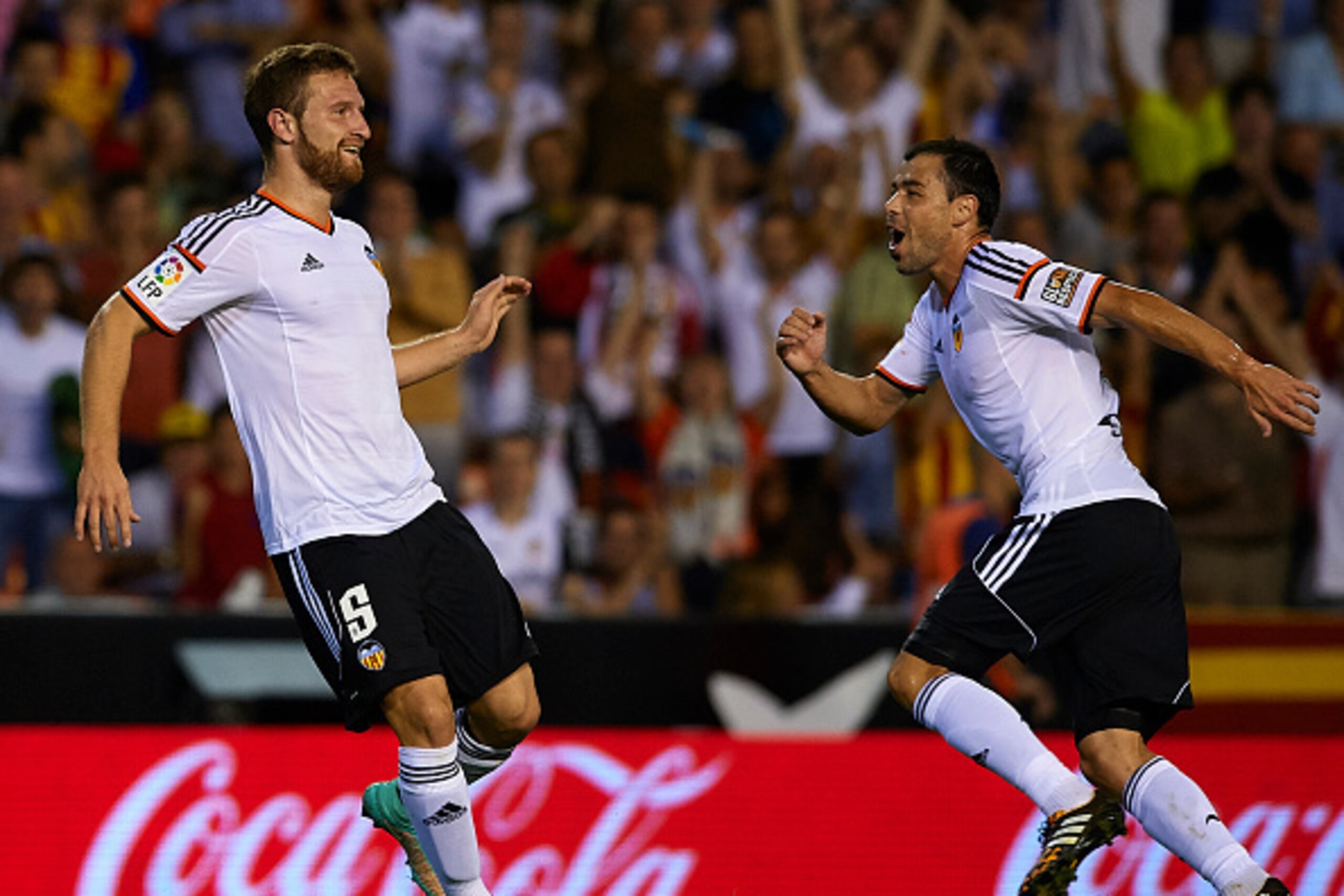 VALENCIA, SPAIN - OCTOBER 25:  Shkodran Mustafi (L) of Valencia celebrates scoring with his teammate Javi Fuego during the La Liga match between Valencia CF and Elche CF at Estadio Mestalla on October 25, 2014 in Valencia, Spain.  (Photo by Manuel Queimad
