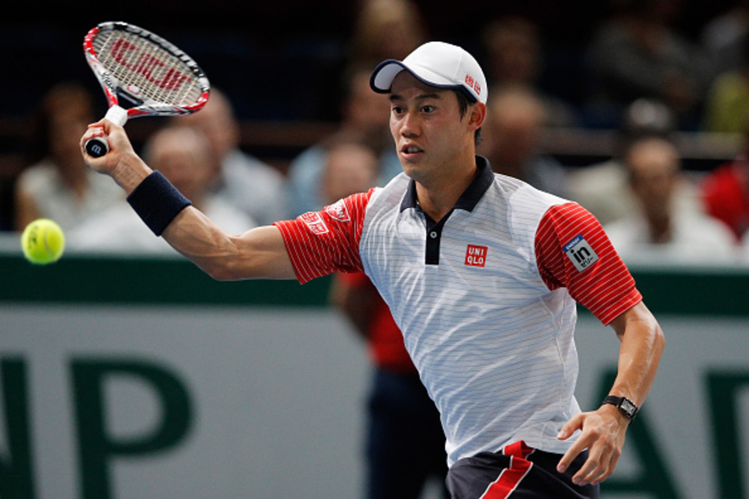 PARIS, FRANCE - NOVEMBER 01:  Kei Nishikori of Japan in action against Novak Djokovic of Serbia in their semi final match during day 6 of the BNP Paribas Masters held at the at Palais Omnisports de Bercy on November 1, 2014 in Paris, France.  (Photo by De
