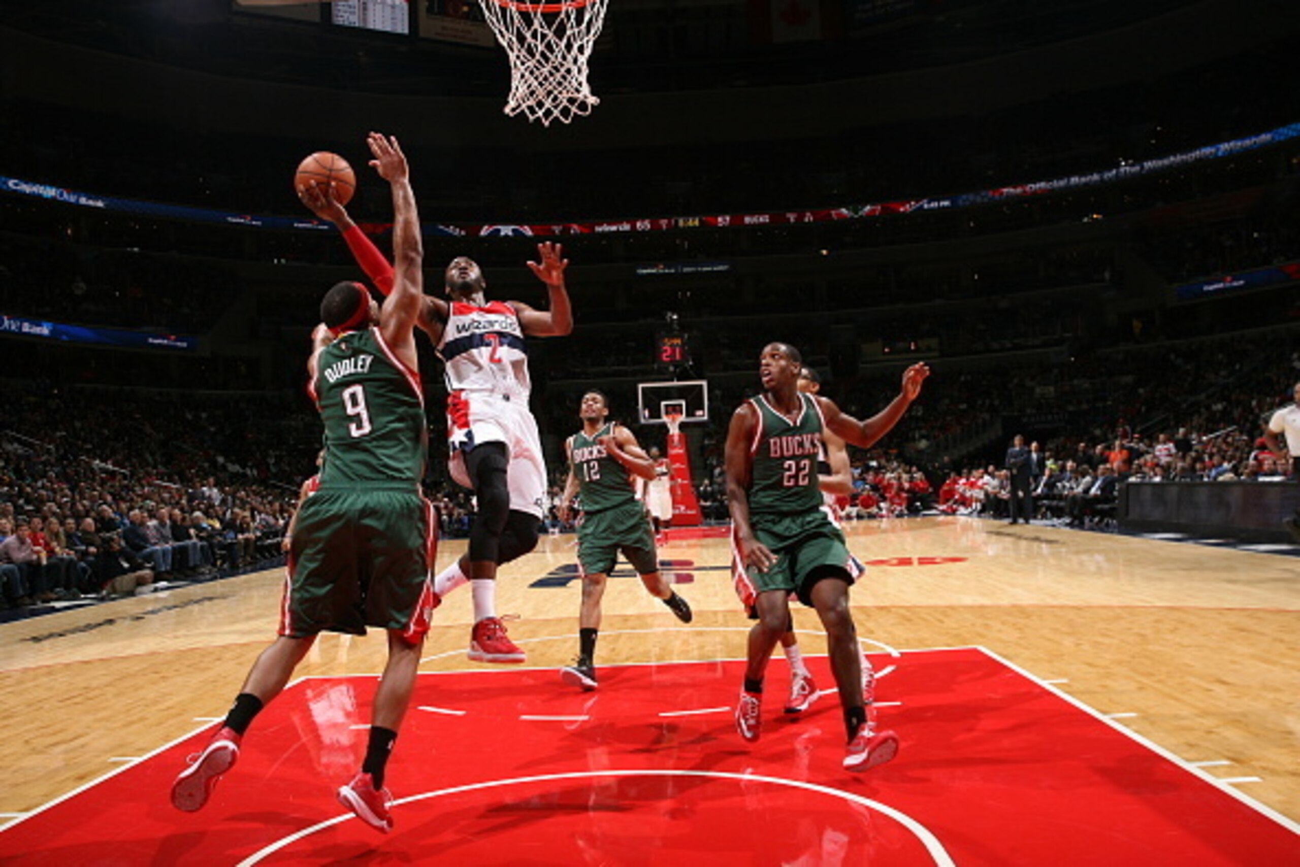 WASHINGTON, DC - NOVEMBER 1: John Wall #2 of the Washington Wizards shoots against Jared Dudley #9 of the Milwaukee Bucks during a game at the Verizon Center on November 1, 2014 in Washington, DC. NOTE TO USER: User expressly acknowledges and agrees that,