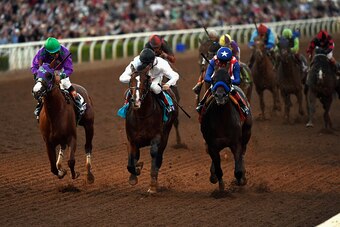 ARCADIA, CA - NOVEMBER 01:  Jockey Martin Garcia atop Bayern (L) leads jockey Victor Espinoza atop California Chrome, and jockey Jamie Spencer atop Toast of New York en route to winning the 2014 Breeders' Cup Classic at Santa Anita Park on November 1, 201
