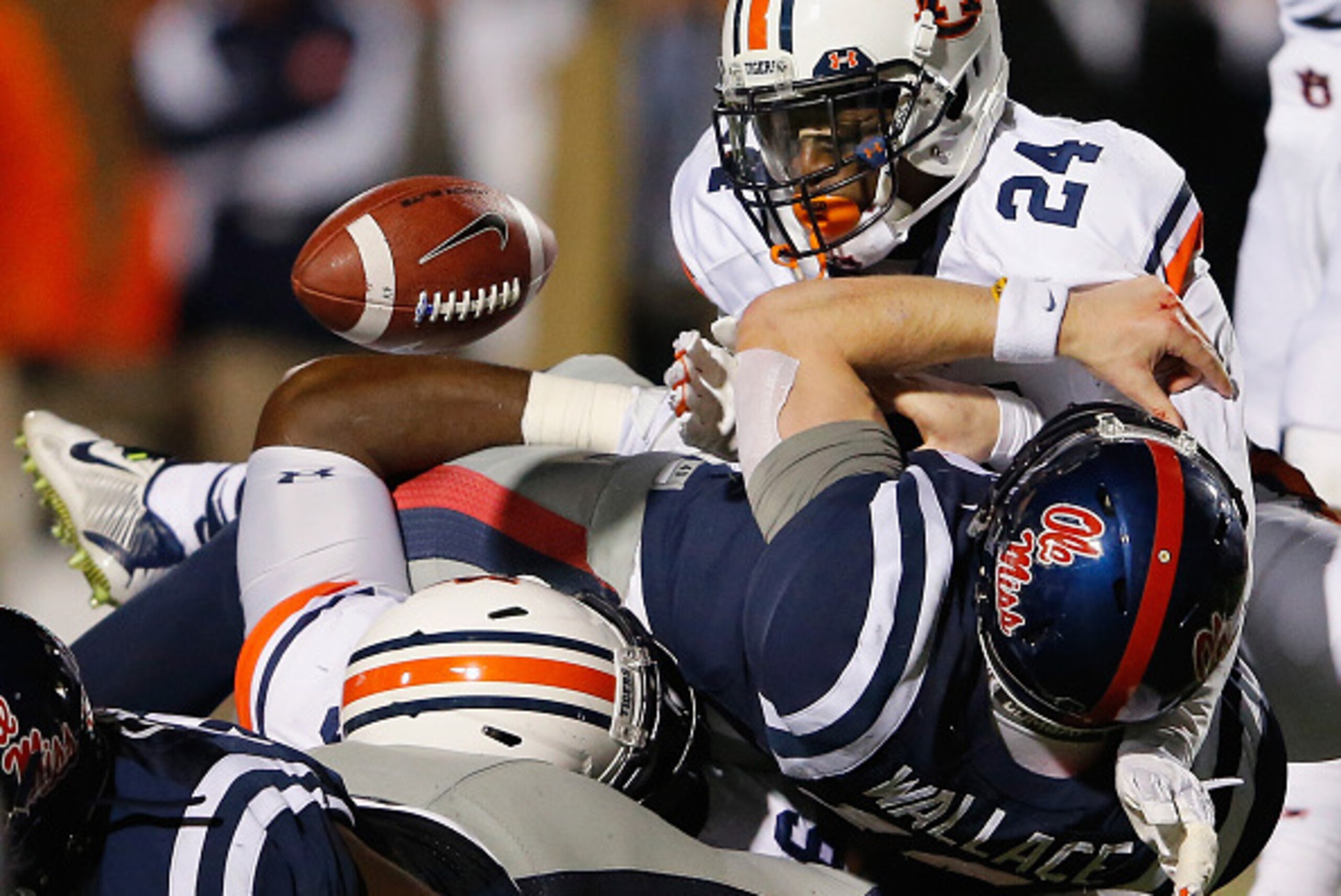 OXFORD, MS - NOVEMBER 01:  Derrick Moncrief #24 of the Auburn Tigers forces a fumble by quarterback Bo Wallace #14 of the Mississippi Rebels in the fourth quarter at Vaught-Hemingway Stadium on November 1, 2014 in Oxford, Mississippi. Auburn defeated Miss