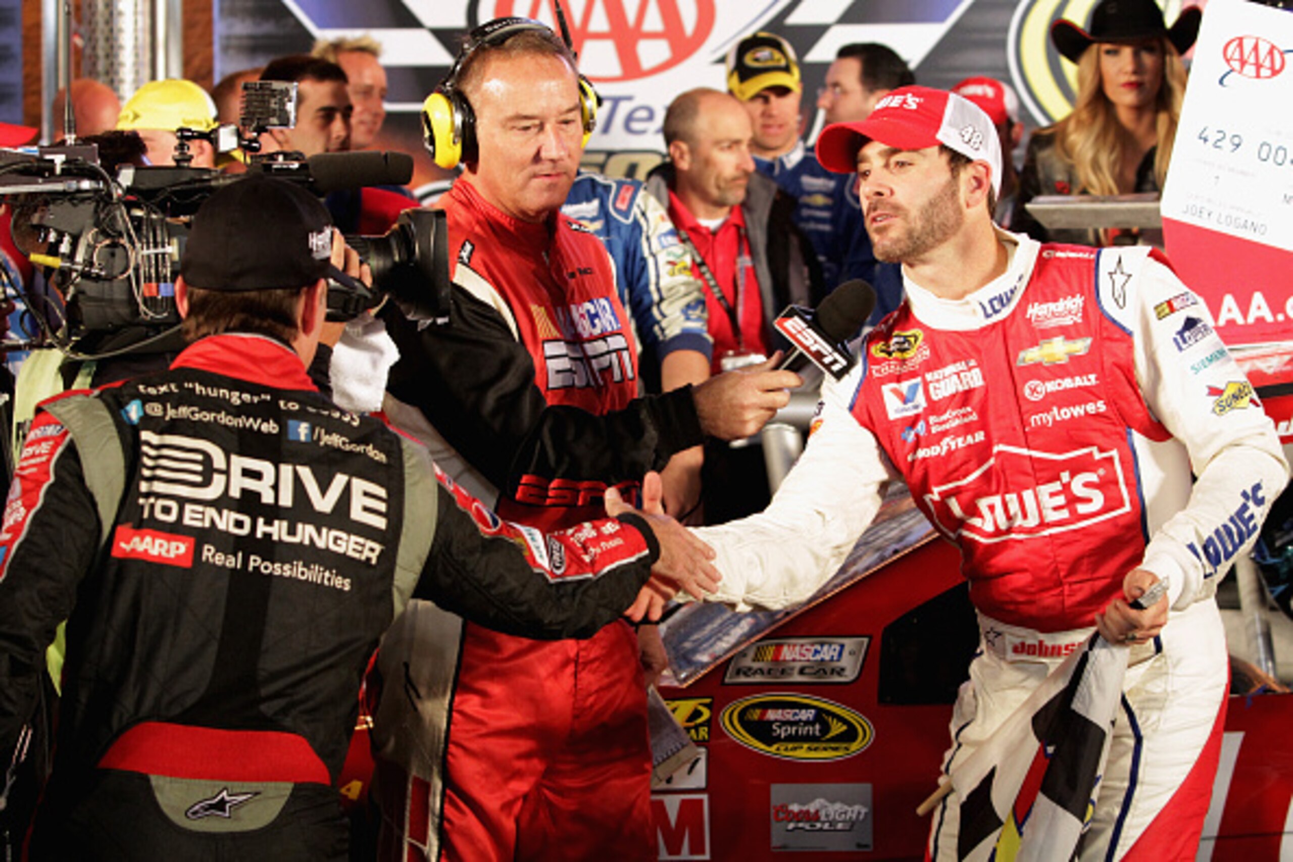 FORT WORTH, TX - NOVEMBER 02:  Jeff Gordon, driver of the #24 Drive To End Hunger Chevrolet, congratulates Jimmie Johnson, driver of the #48 Lowe's Red Vest Chevrolet, after his win in the NASCAR Sprint Cup Series AAA Texas 500 at Texas Motor Speedway on 