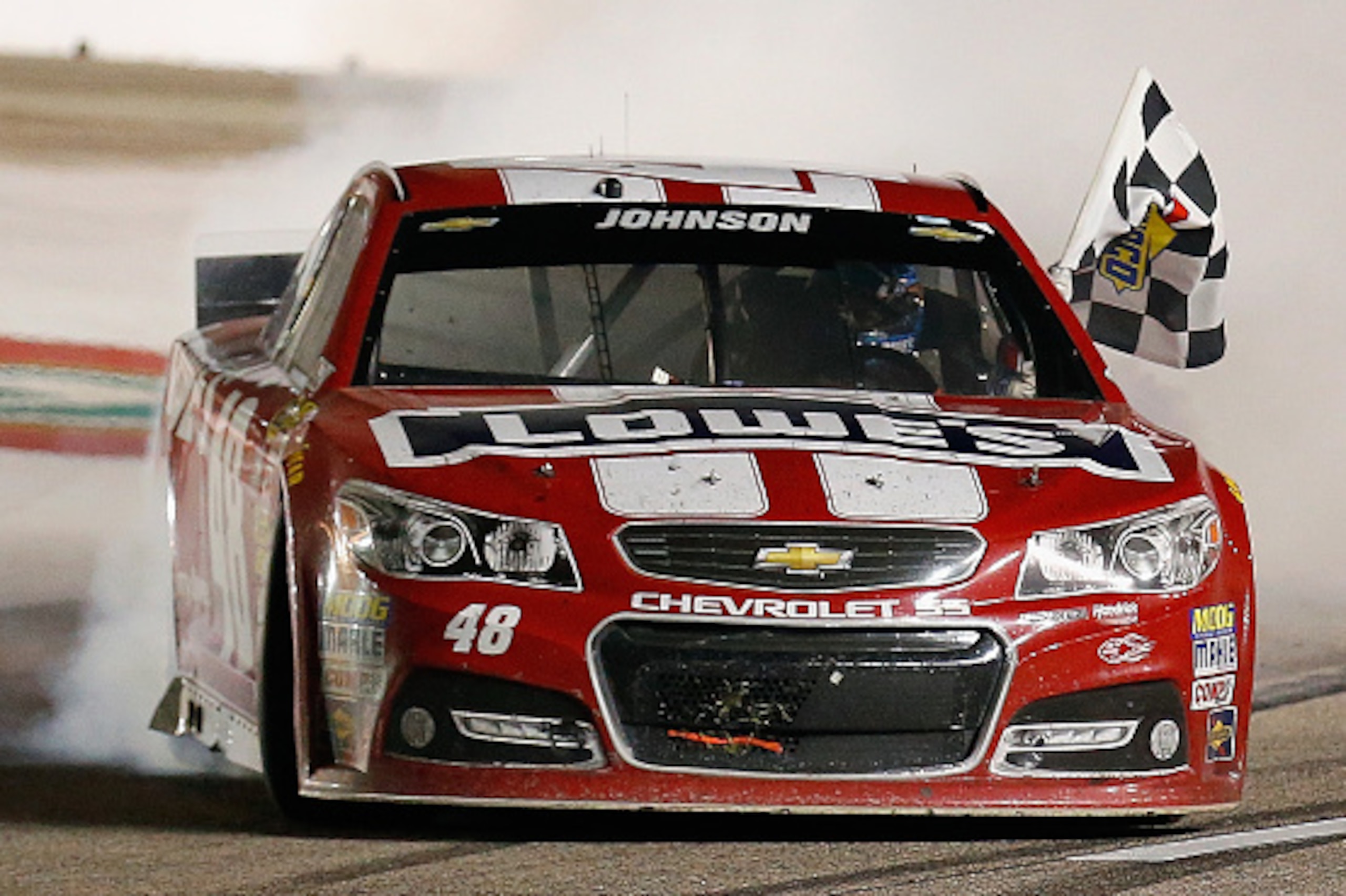 FORT WORTH, TX - NOVEMBER 02:  Jimmie Johnson, driver of the #48 Lowe's Red Vest Chevrolet, celebrates with a burnout after winning the NASCAR Sprint Cup Series AAA Texas 500 at Texas Motor Speedway on November 2, 2014 in Fort Worth, Texas.  (Photo by Tom