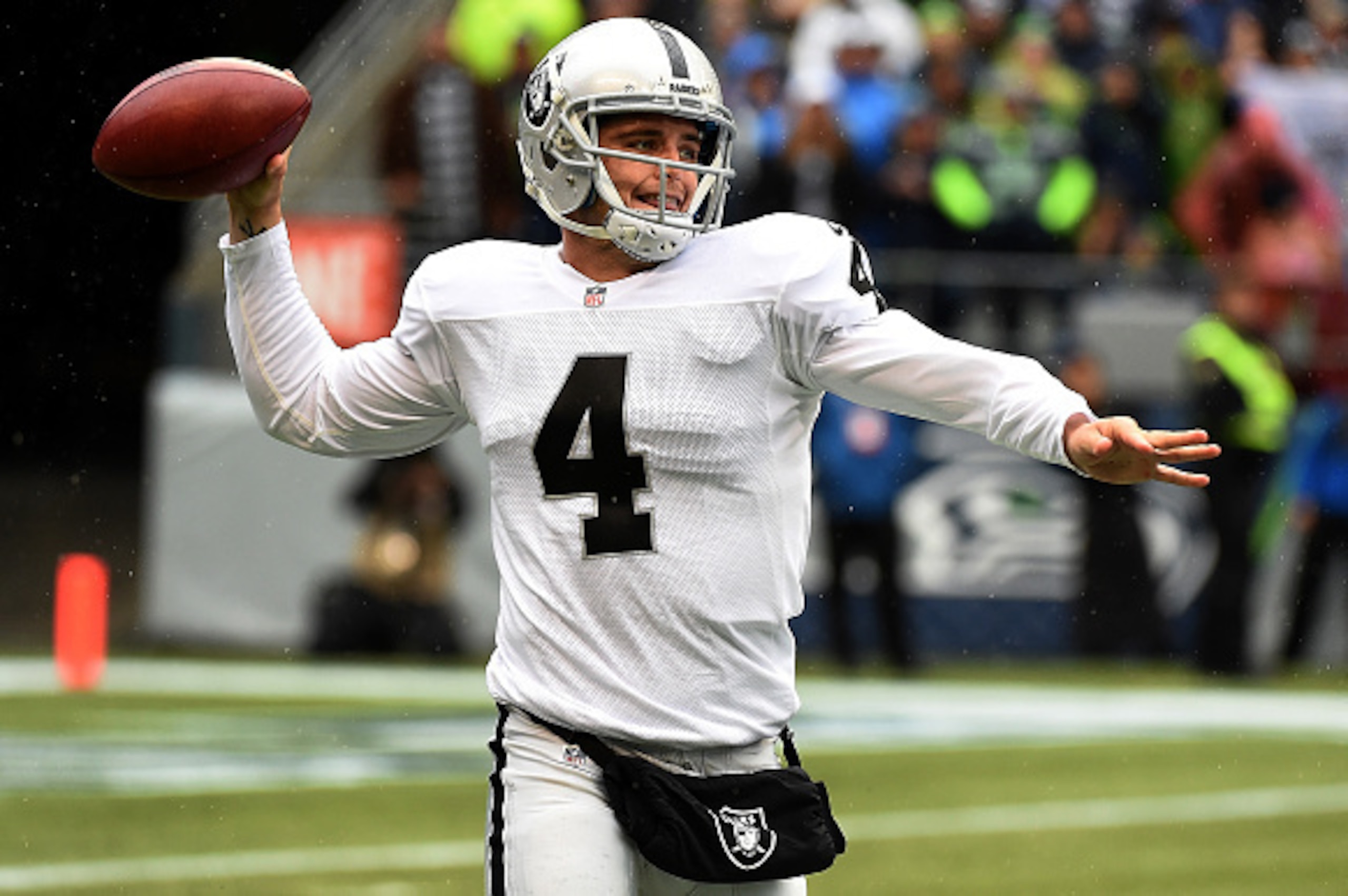 SEATTLE, WA - NOVEMBER 02:  Quarterback Derek Carr #4 of the Oakland Raiders throws the ball during the first quarter of the game against the Seattle Seahawks at CenturyLink Field on November 2, 2014 in Seattle, Washington.  (Photo by Steve Dykes/Getty Im
