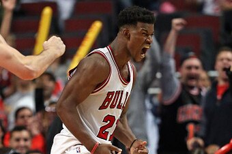 CHICAGO, IL - OCTOBER 16: Jimmy Butler #21 of the Chicago Bulls celebrates a three-point play against the Atlanra Hawks during a preseason game at the United Center on October 16, 2014 in Chicago, Illinois. The Bulls defeated the Hawks 85-84. NOTE TO USER
