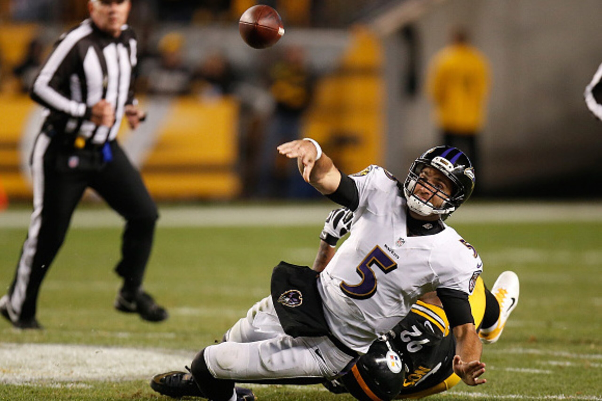 PITTSBURGH, PA - NOVEMBER 02:  Joe Flacco #5 of the Baltimore Ravens throws the ball away while being dragged down by James Harrison #92 of the Pittsburgh Steelers during the third quarter at Heinz Field on November 2, 2014 in Pittsburgh, Pennsylvania.  (