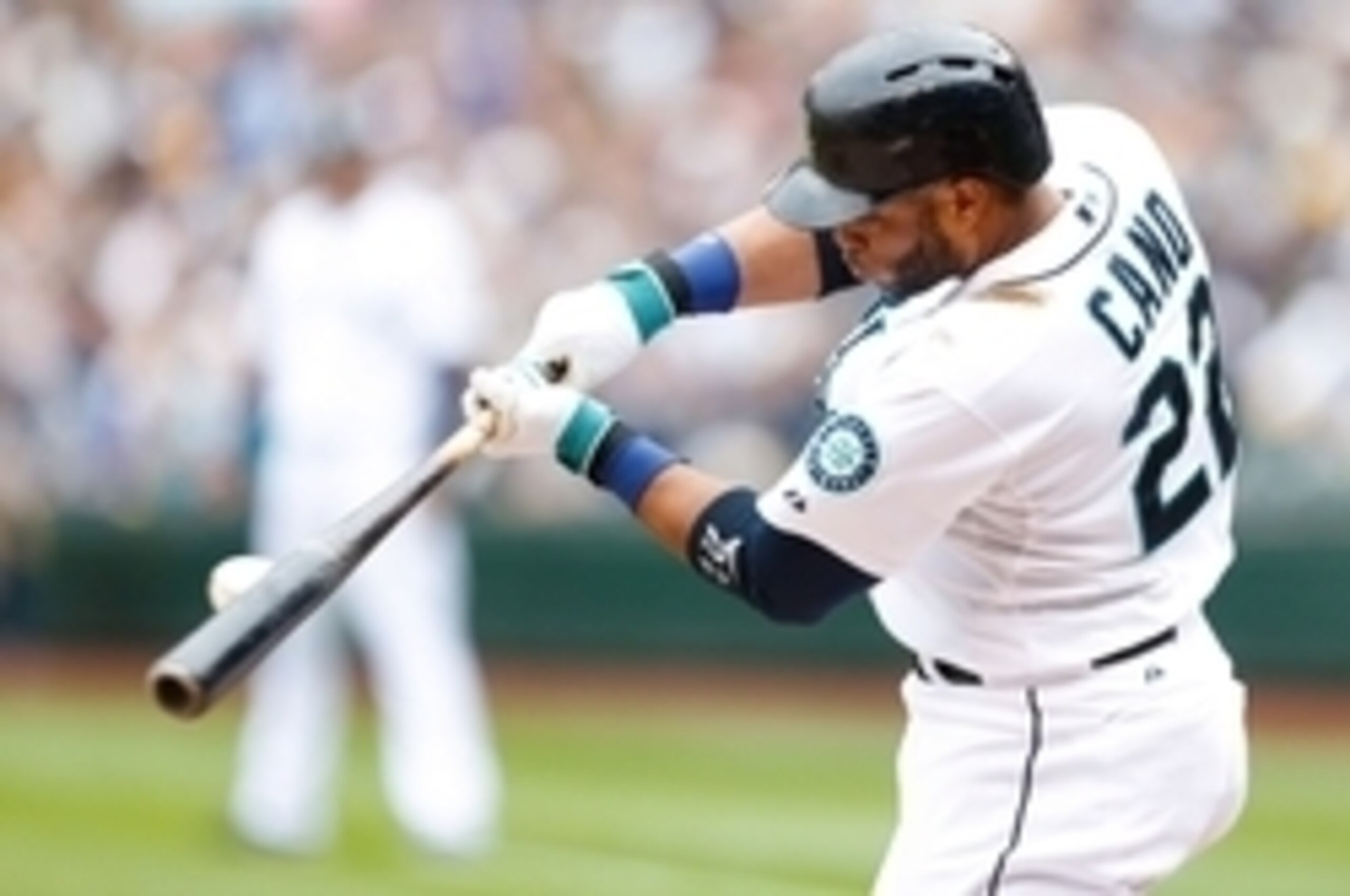 Sep 28, 2014; Seattle, WA, USA; Seattle Mariners second baseman Robinson Cano (22) hits against the Los Angeles Angels during the first inning at Safeco Field. Mandatory Credit: Joe Nicholson-USA TODAY Sports
