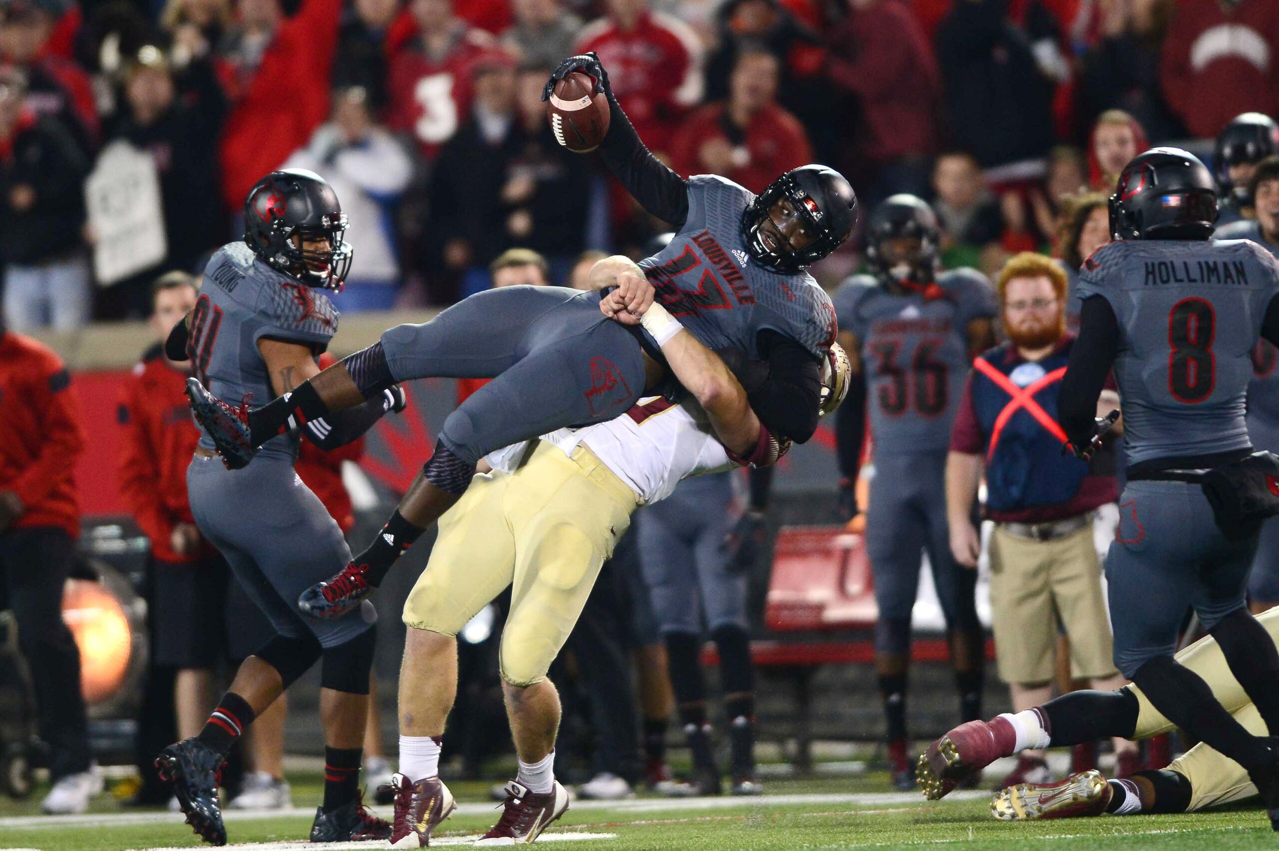 Oct 30, 2014; Louisville, KY, USA; Florida State Seminoles tight end Nick O'Leary (35) tackles Louisville Cardinals linebacker James Burgess (13) after an interception a during the second quarter at Papa John's Cardinal Stadium. Mandatory Credit: Andrew W