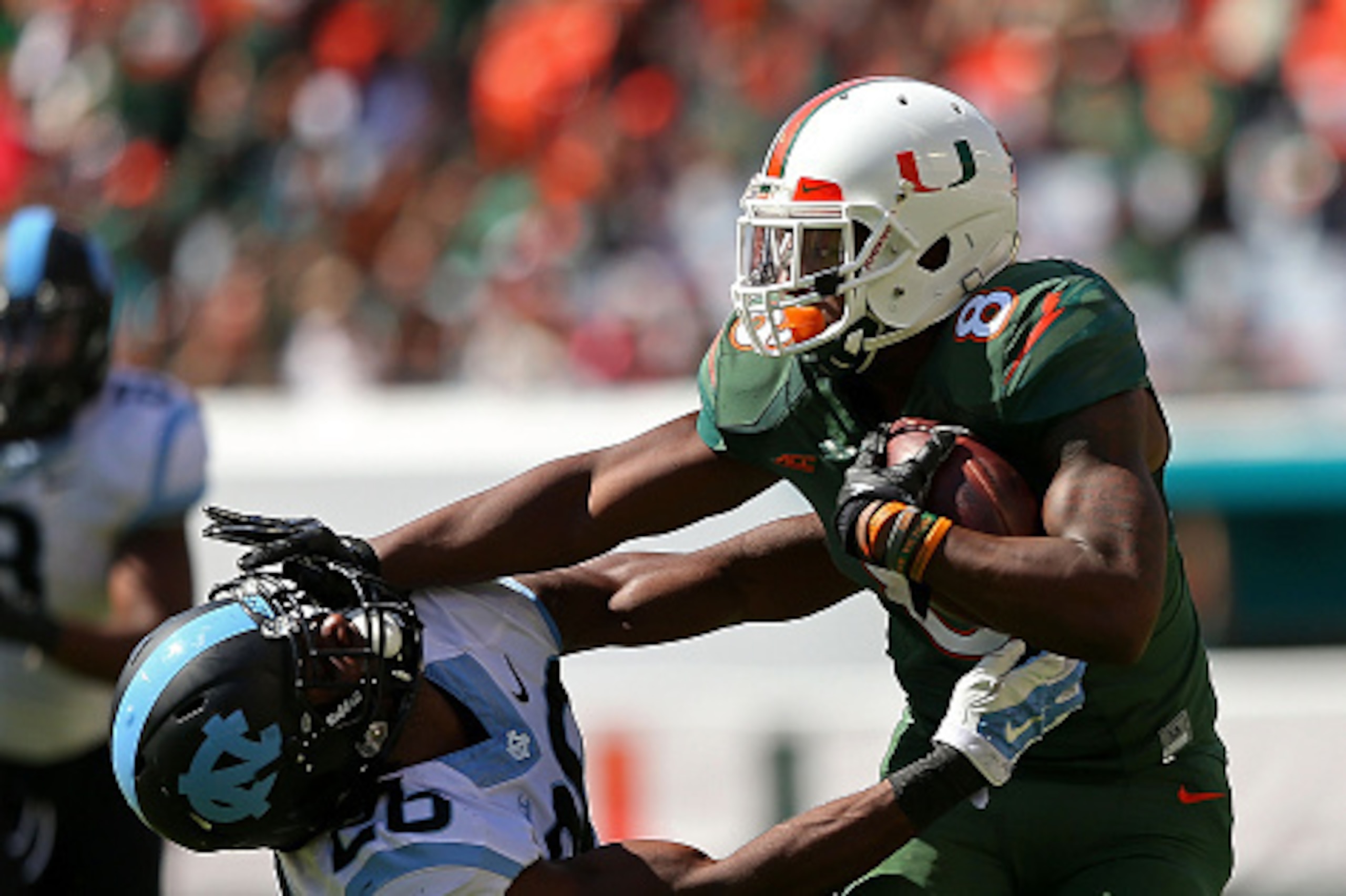 MIAMI GARDENS, FL - NOVEMBER 01:  Duke Johnson #8 of the Miami Hurricanes rushes for a first down during a game against the North Carolina Tar Heels at Sun Life Stadium on November 1, 2014 in Miami Gardens, Florida.  (Photo by Mike Ehrmann/Getty Images)