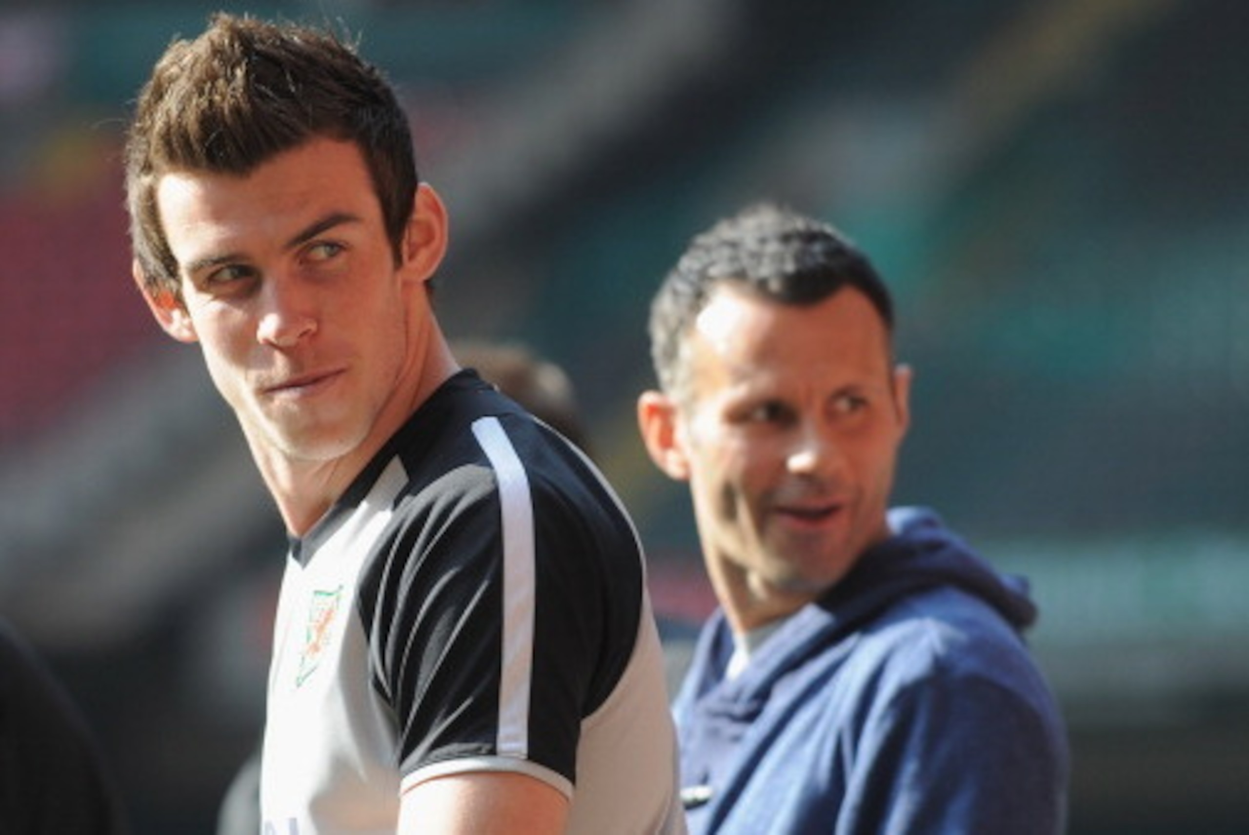 CARDIFF, WALES - MARCH 25:  Gareth Bale looks on as he sits out with an injury with Ryan Giggs during the Wales training session ahead of their UEFA EURO 2012 qualifier against England on March 25, 2011 in Cardiff, Wales.  (Photo by Michael Regan/Getty Im